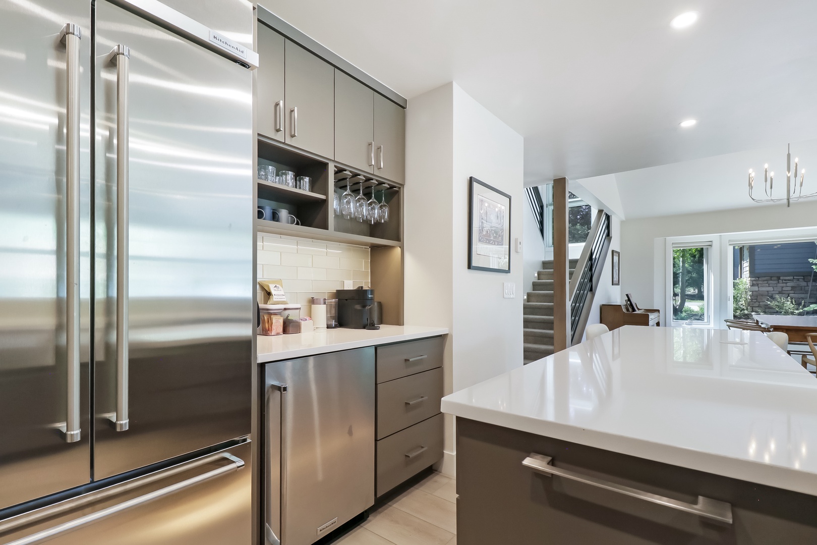 Your modern chef's kitchen features sleek stainless steel appliances, ample counter space, and a handy wine glass rack—all the essentials for whipping up your favorite meals during your stay.