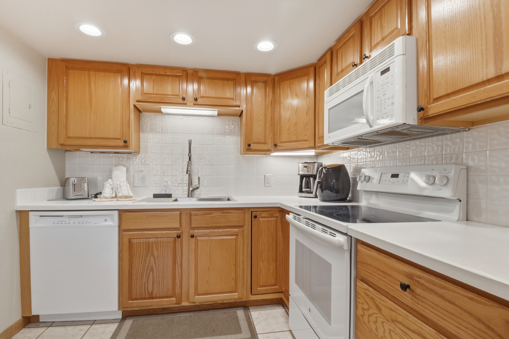 Your fully-equipped kitchen awaits with warm wood cabinets, modern appliances, and everything you need to prepare delicious meals during your stay.