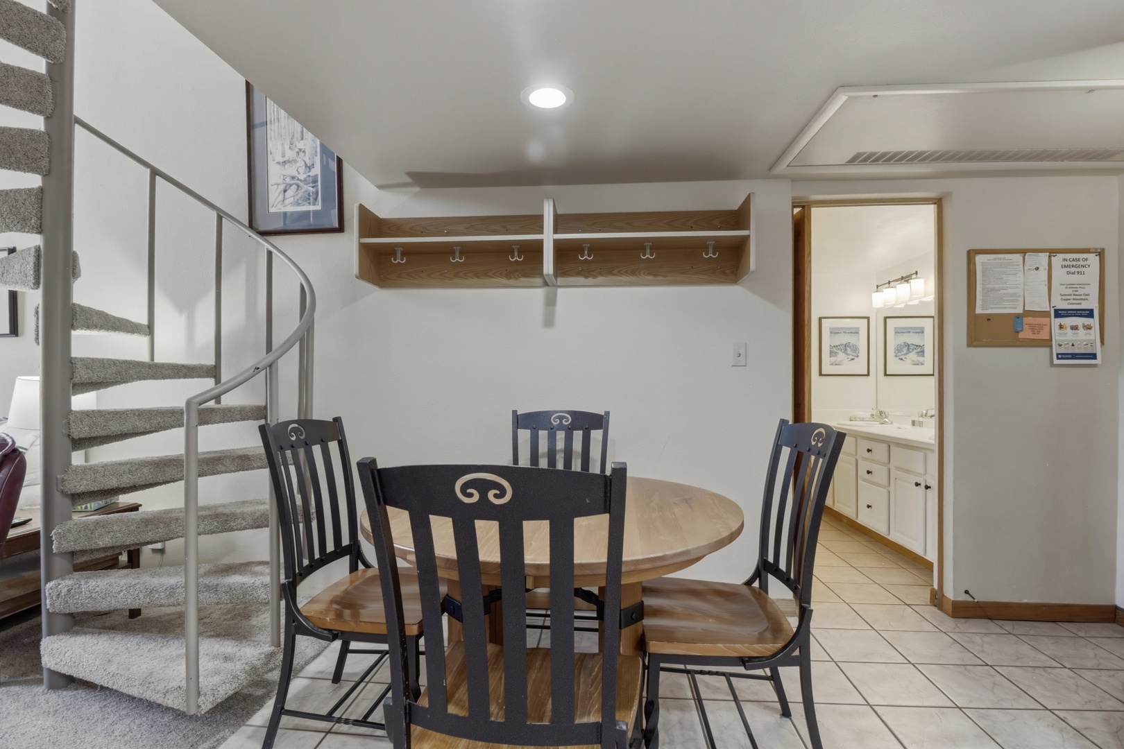 Gather around your cozy dining table with loved ones, surrounded by thoughtful touches like hooks for your belongings.