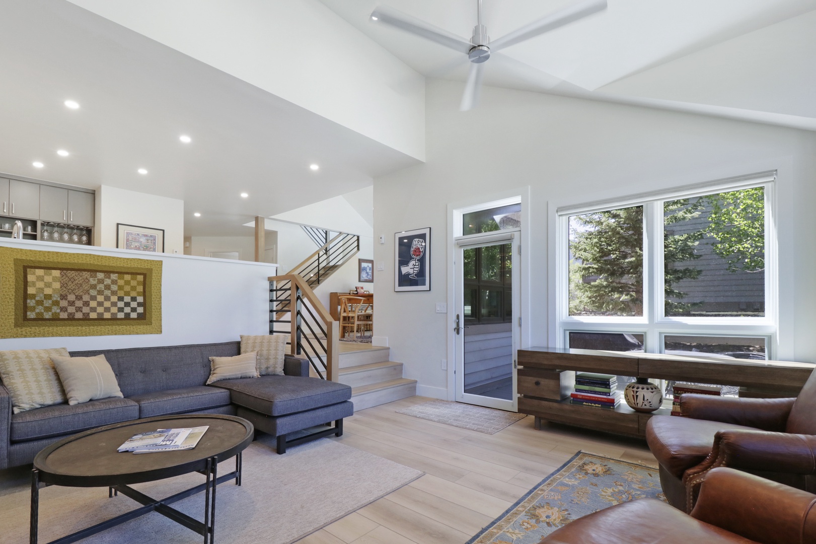 Settle into this bright, airy living space where high ceilings and abundant natural light create your perfect home base. Stylish furnishings and an open layout invite you to relax after adventures.