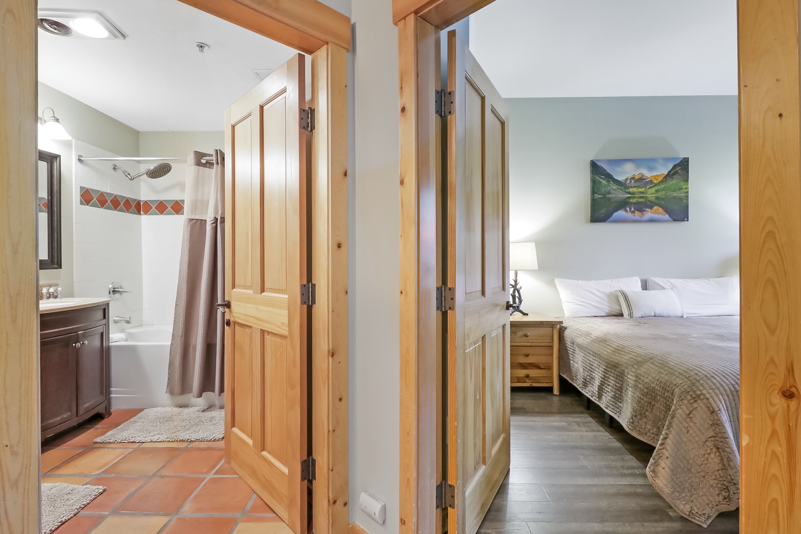 Your peaceful retreat features a cozy bedroom with a plush bed and charming wood accents, plus a private bathroom with both tub and shower to refresh after your adventures.