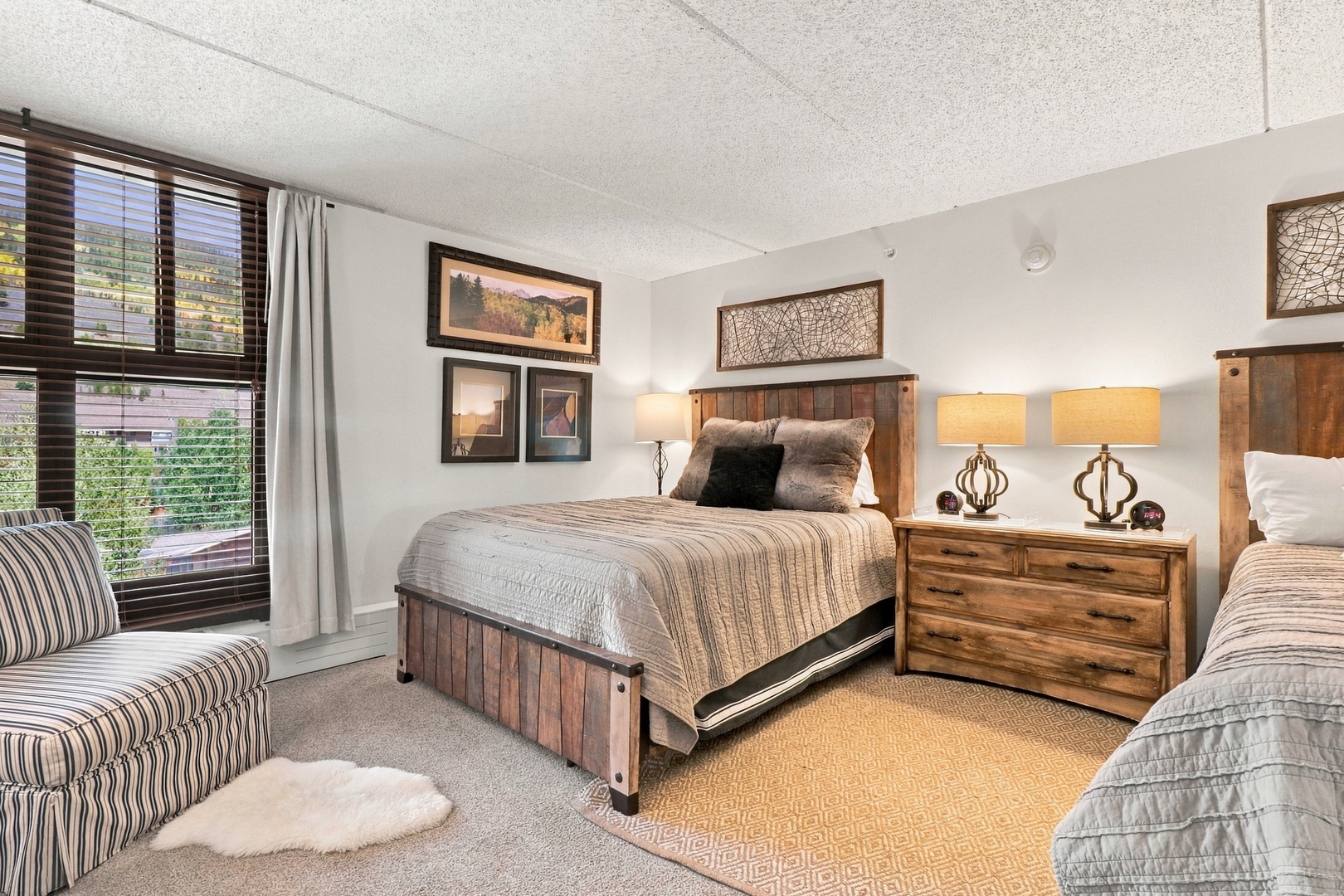 Unwind in your peaceful bedroom, where rustic wood furnishings and soft bedding create a cozy retreat, perfect for restful nights after mountain adventures.