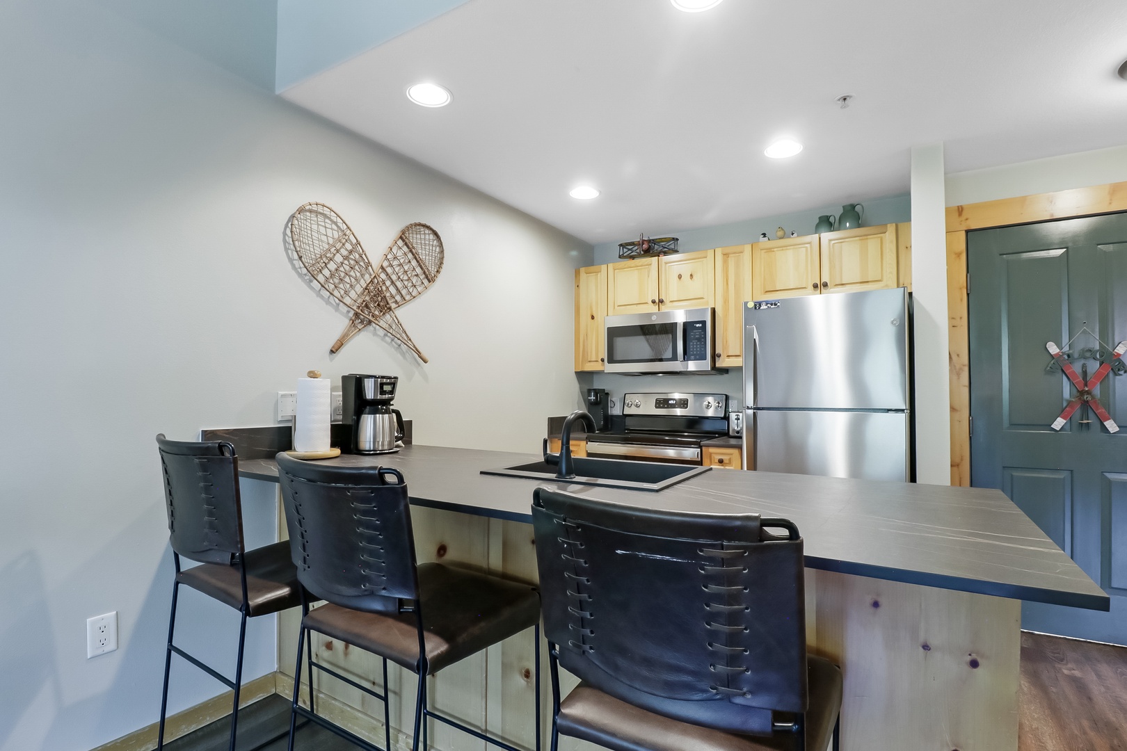 Gather around the breakfast bar for morning coffee or plan your next adventure in this fully equipped kitchen with modern appliances and cozy mountain charm.