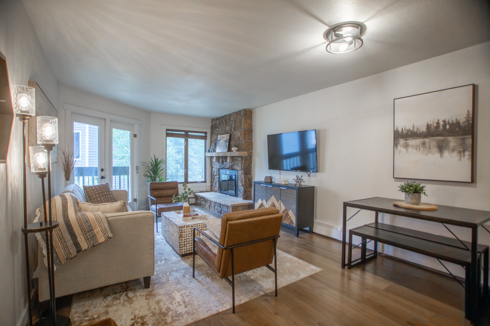 Unwind in your cozy living room, where natural light pours through the balcony doors and a warm fireplace sets the perfect mood for relaxing evenings together.