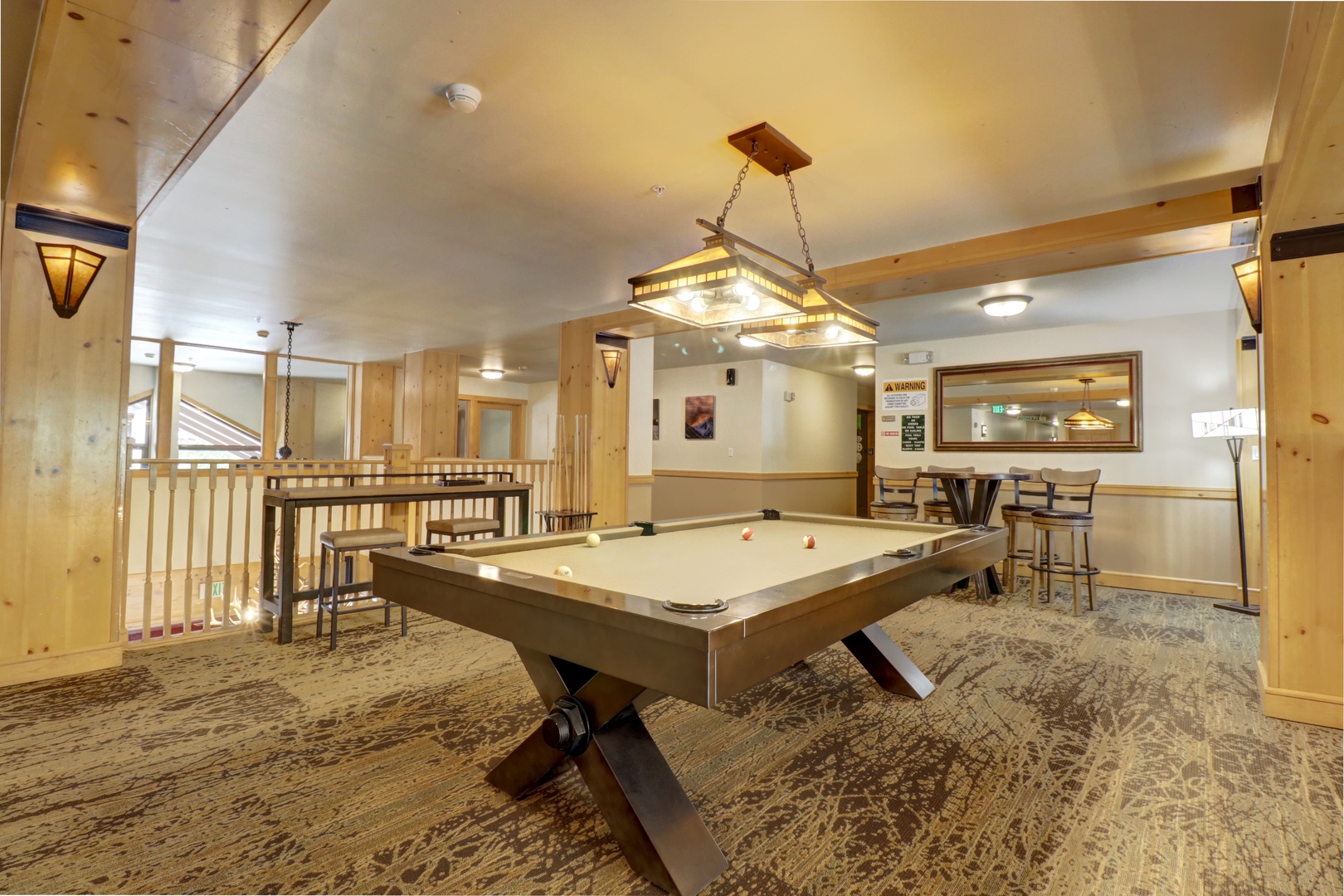 Step into your own game room with a stunning billiard table, warm wood accents, and a cozy lounge area—perfect for unforgettable nights with friends and family.