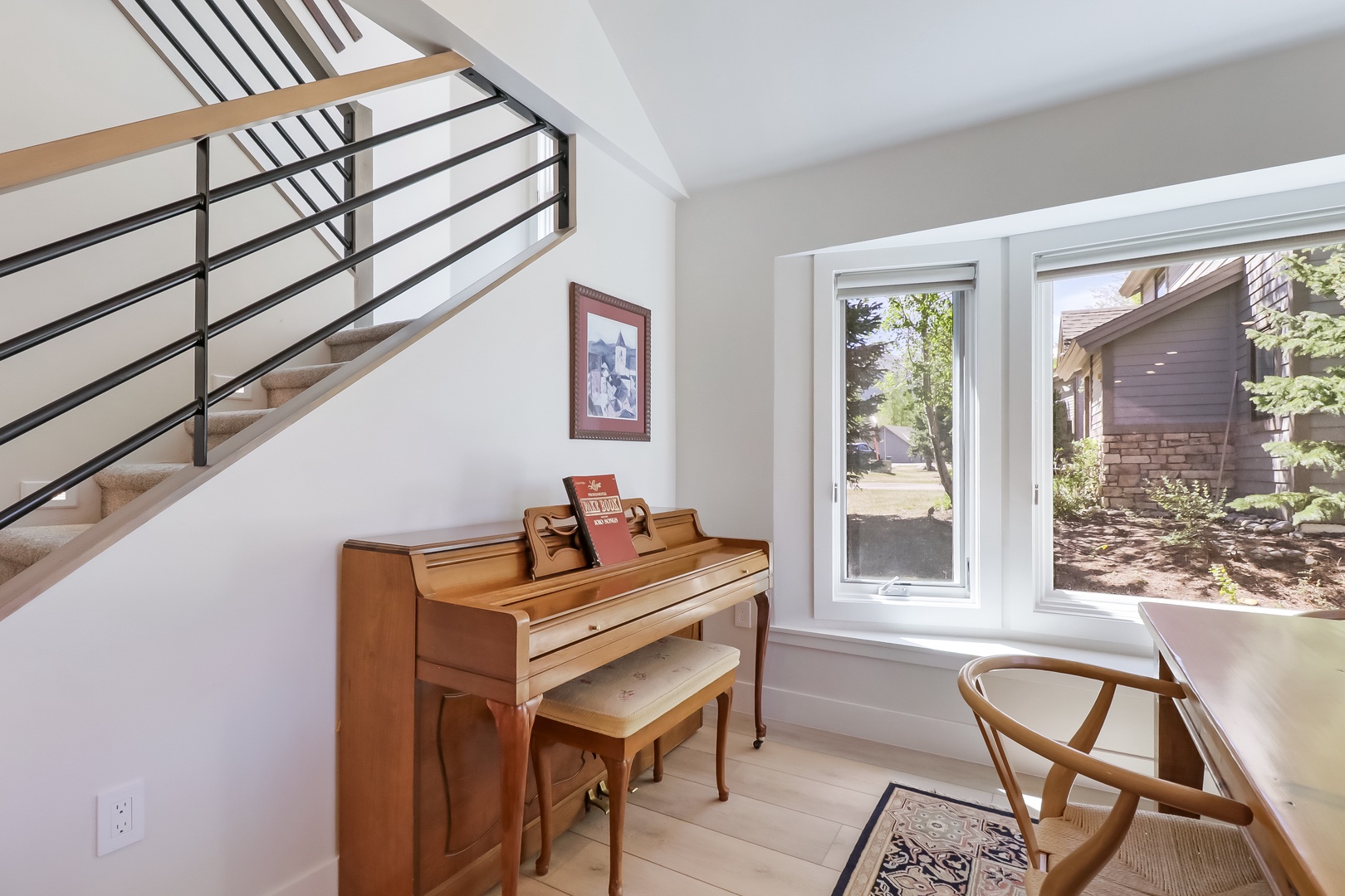 Your creative sanctuary awaits with a beautifully lit space featuring a classic piano and elegant seating—perfect for quiet moments or musical inspiration during your stay.
