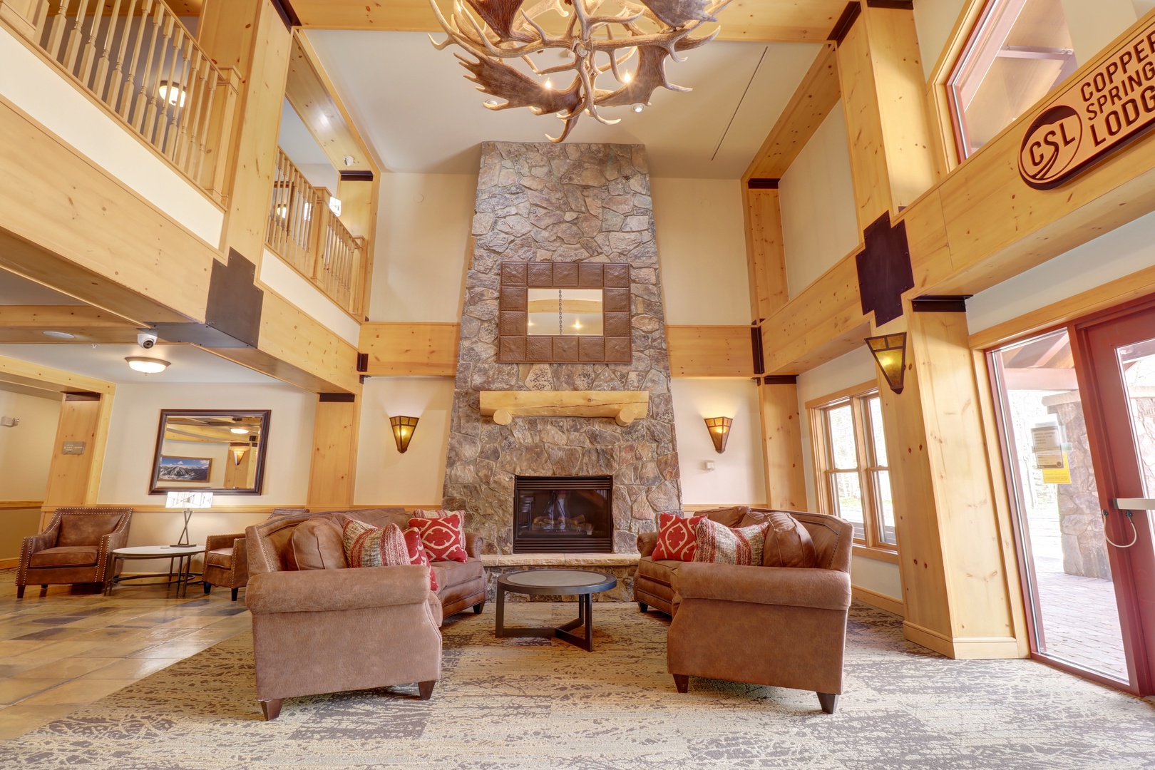 Relax in the inviting lodge lobby, where a soaring stone fireplace and cozy seating create a warm mountain retreat after your day of adventure.