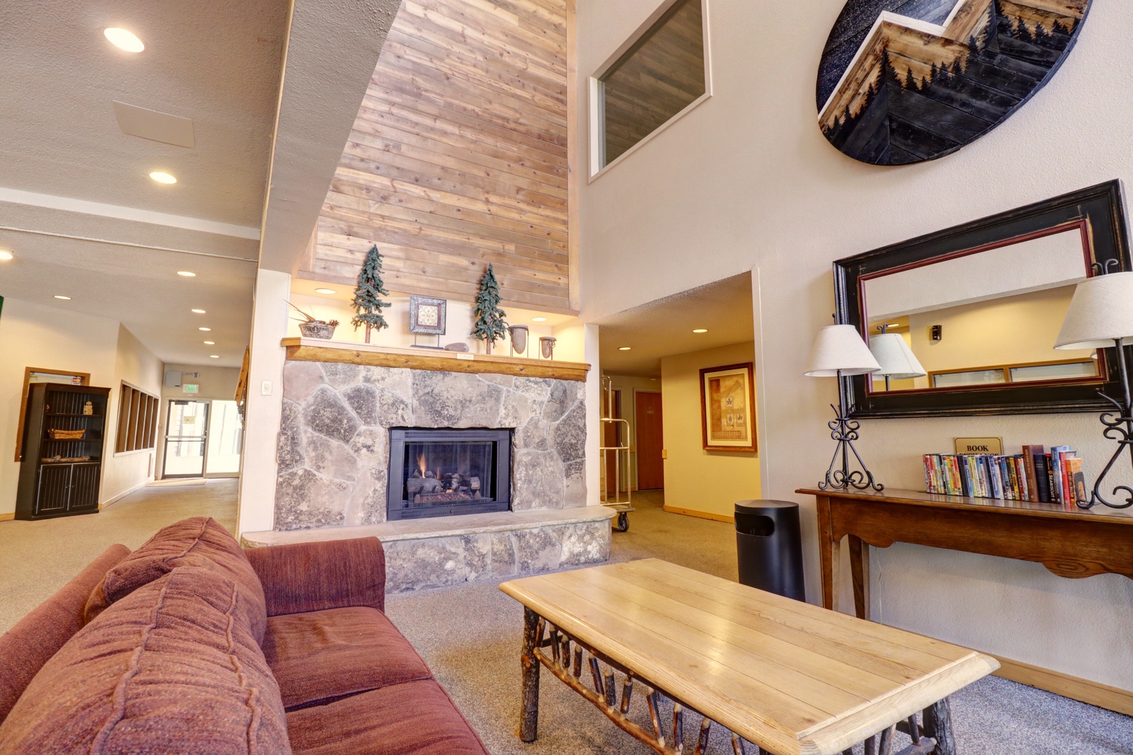 Unwind by the stone fireplace in this cozy lobby with comfortable seating and mountain-inspired decor.