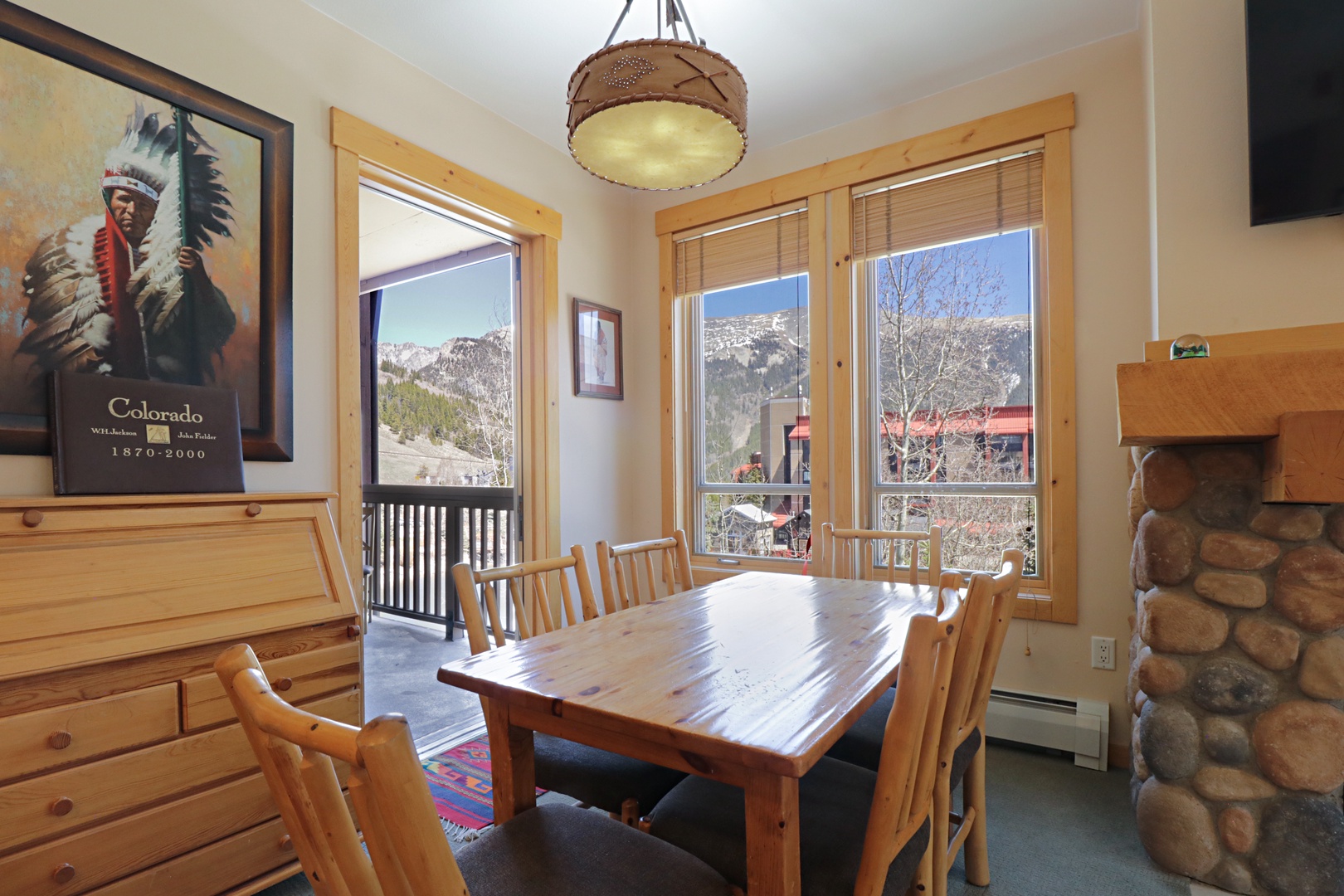 Gather around your rustic dining table where mountain views frame every meal through expansive windows.