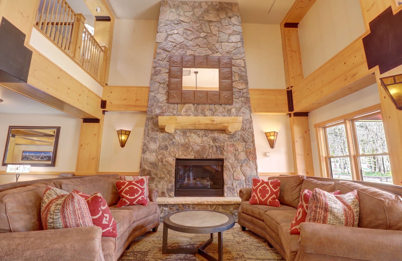Unwind in your spacious living room with soaring ceilings, a dramatic stone fireplace, and plush leather sofas that invite you to relax after your mountain adventures.