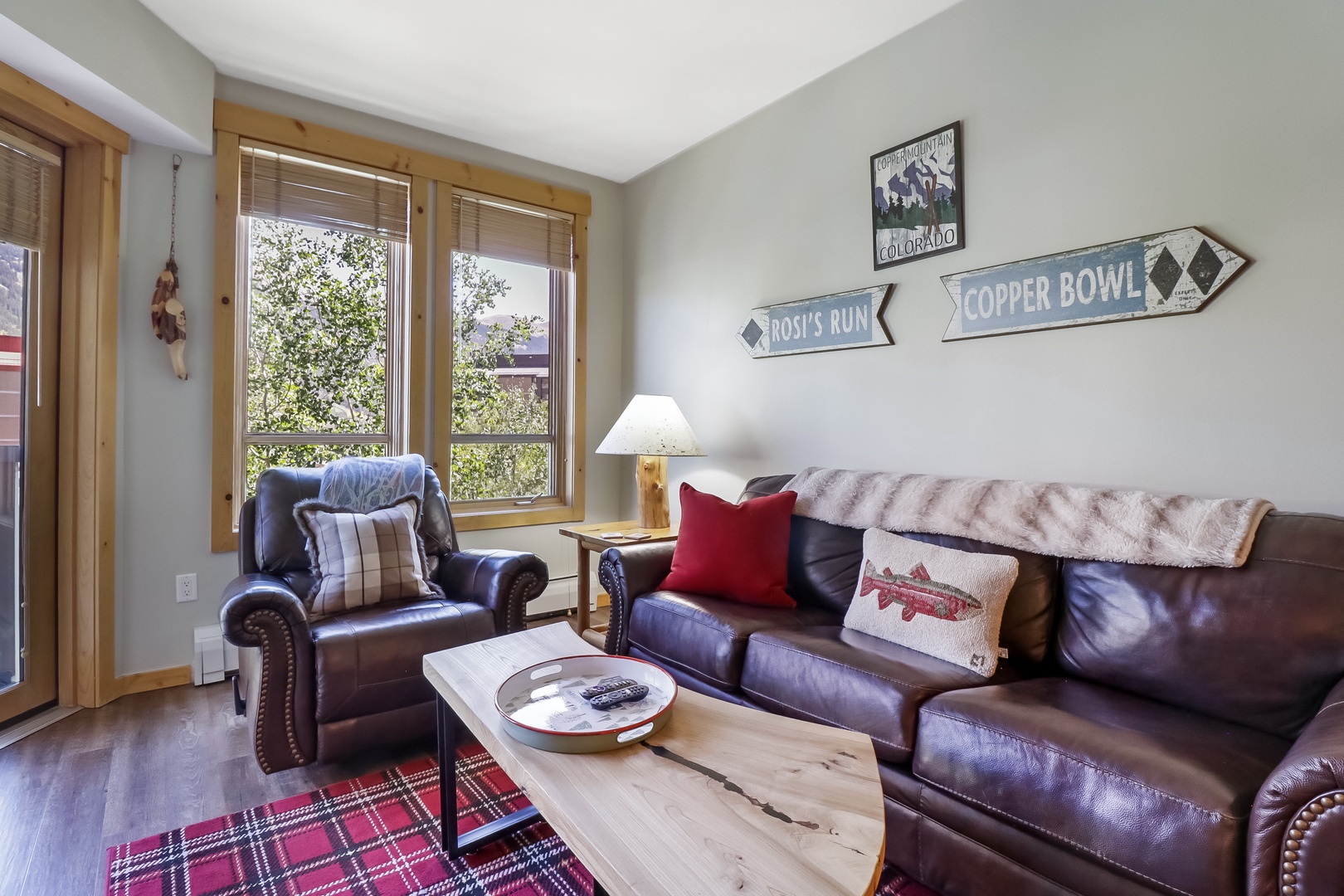 Sink into rich leather seating and your favorite reads with natural light streaming through windows framing trees and mountain charm beyond.