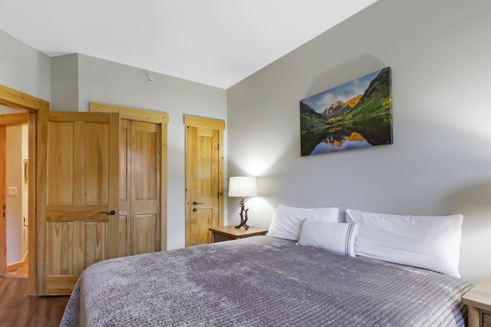 Sink into crisp white linens and let natural light warm the soft gray tones around you, creating your perfect retreat after a day of adventure.
