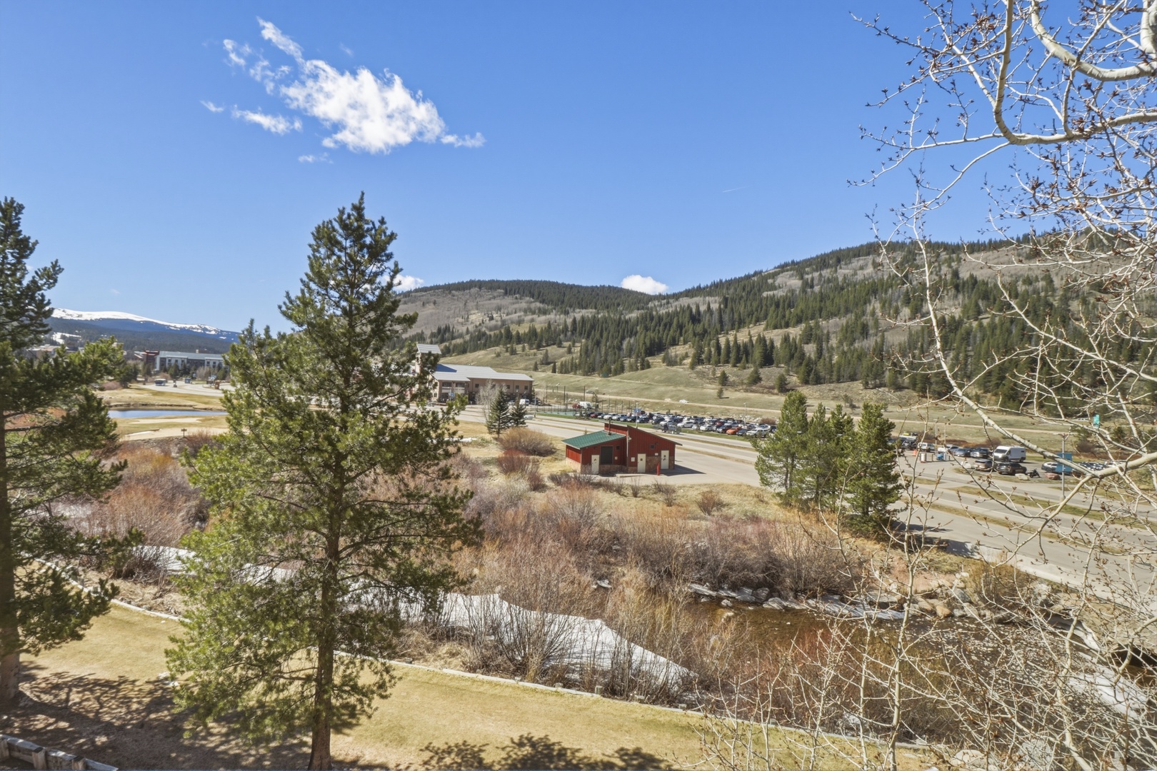 Mountain valley views showcase forested slopes and dramatic alpine scenery surrounding the area.