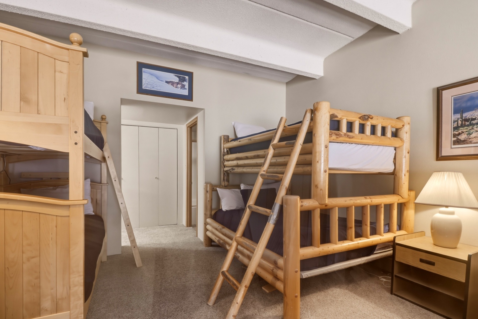 Sleep soundly in your cozy mountain-style room with twin bunk beds, perfect for families or groups sharing adventures together.