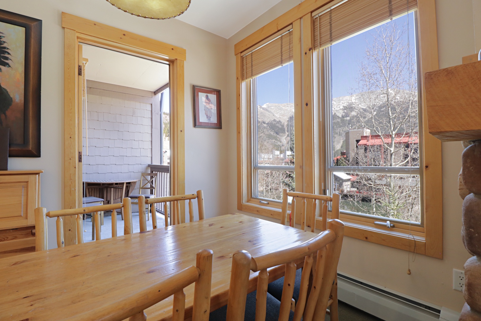 Gather around your rustic wooden dining table as breathtaking mountain views frame every meal through expansive corner windows.