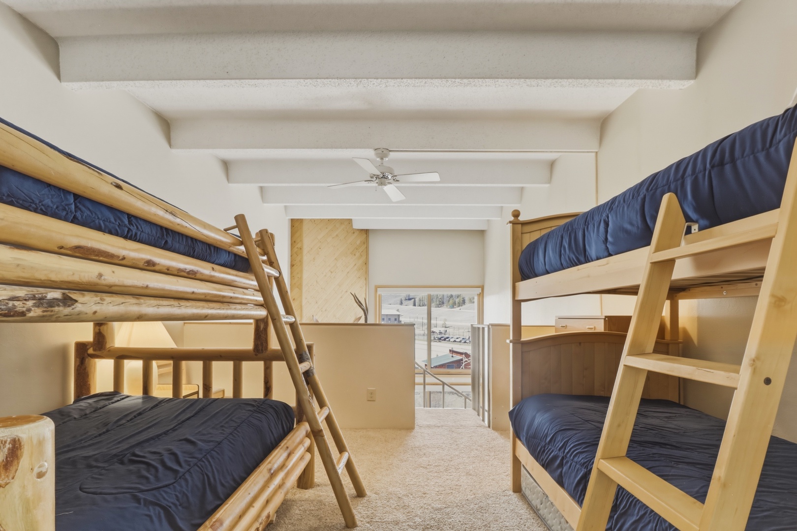 Your cozy bunk room features sturdy wooden beds with navy bedding, perfect for groups or families seeking comfortable shared accommodation.