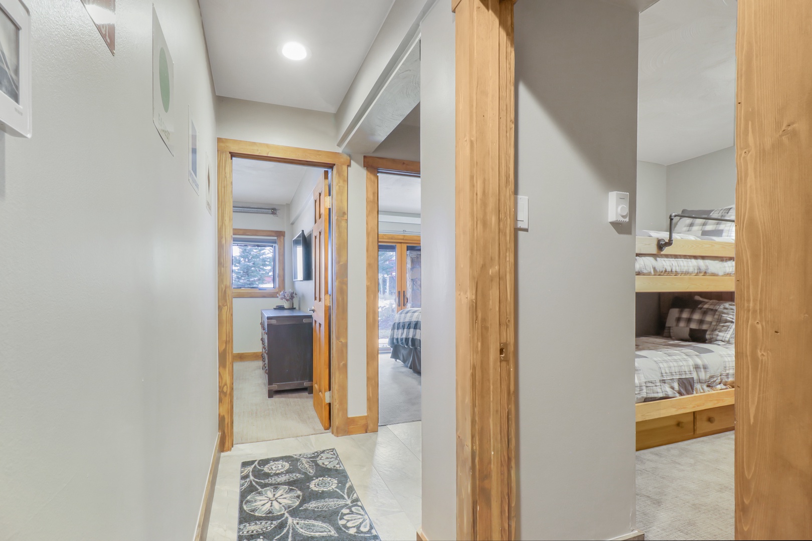 Step into your cozy mountain retreat where warm wood accents and thoughtful design create the perfect family getaway, with comfortable bunk beds ready for restful nights after days of adventure.