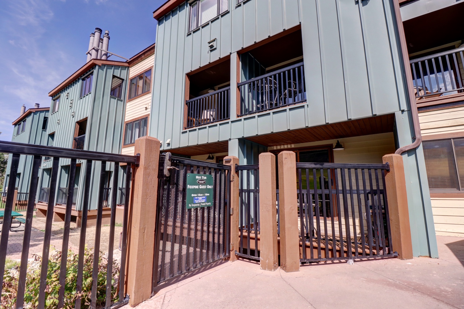 Modern multi-story vacation rental building with private balconies and gated entrance for secure access.