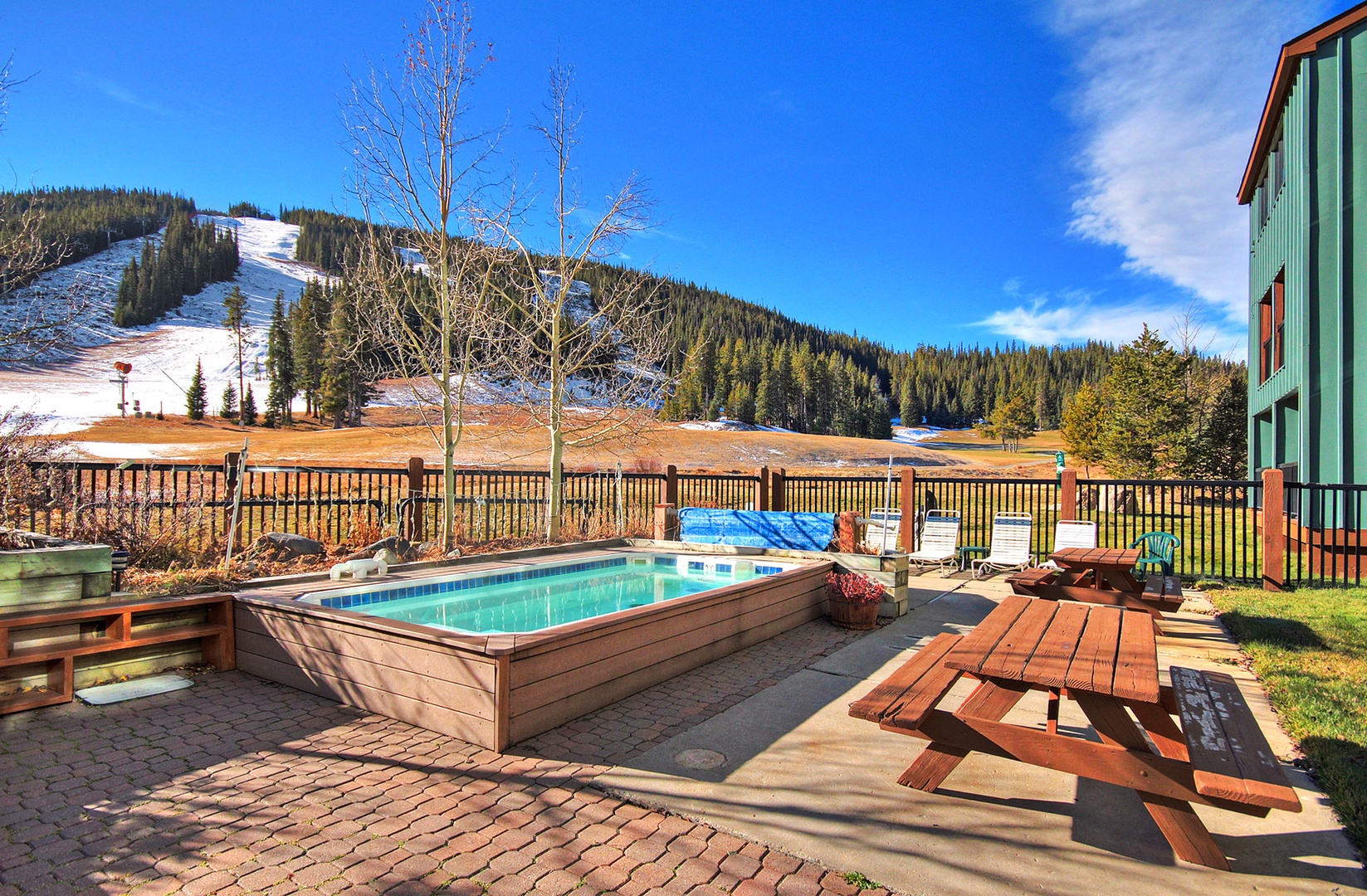 Soak in your private hot tub while taking in breathtaking mountain views and nearby ski slopes on this sunny deck.