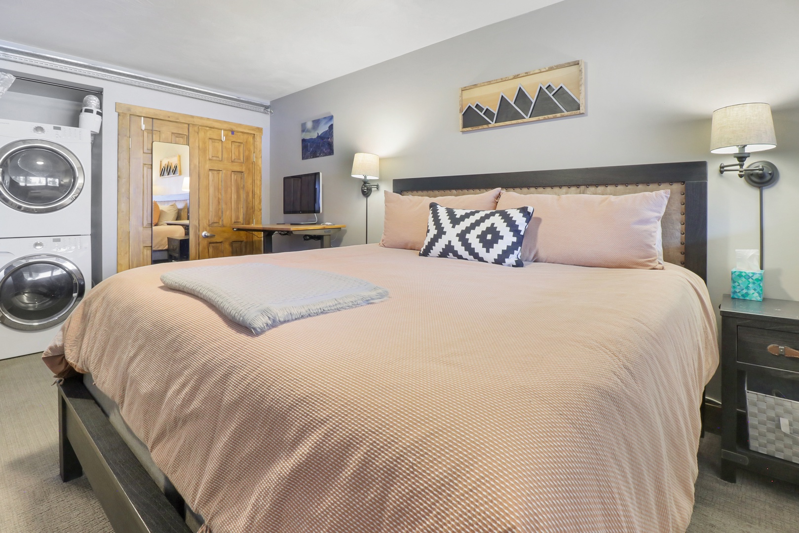 Sink into this cozy mountain-inspired bedroom where soft linens and thoughtful touches await your arrival. The convenient in-room washer and dryer mean you can pack light for your adventures.