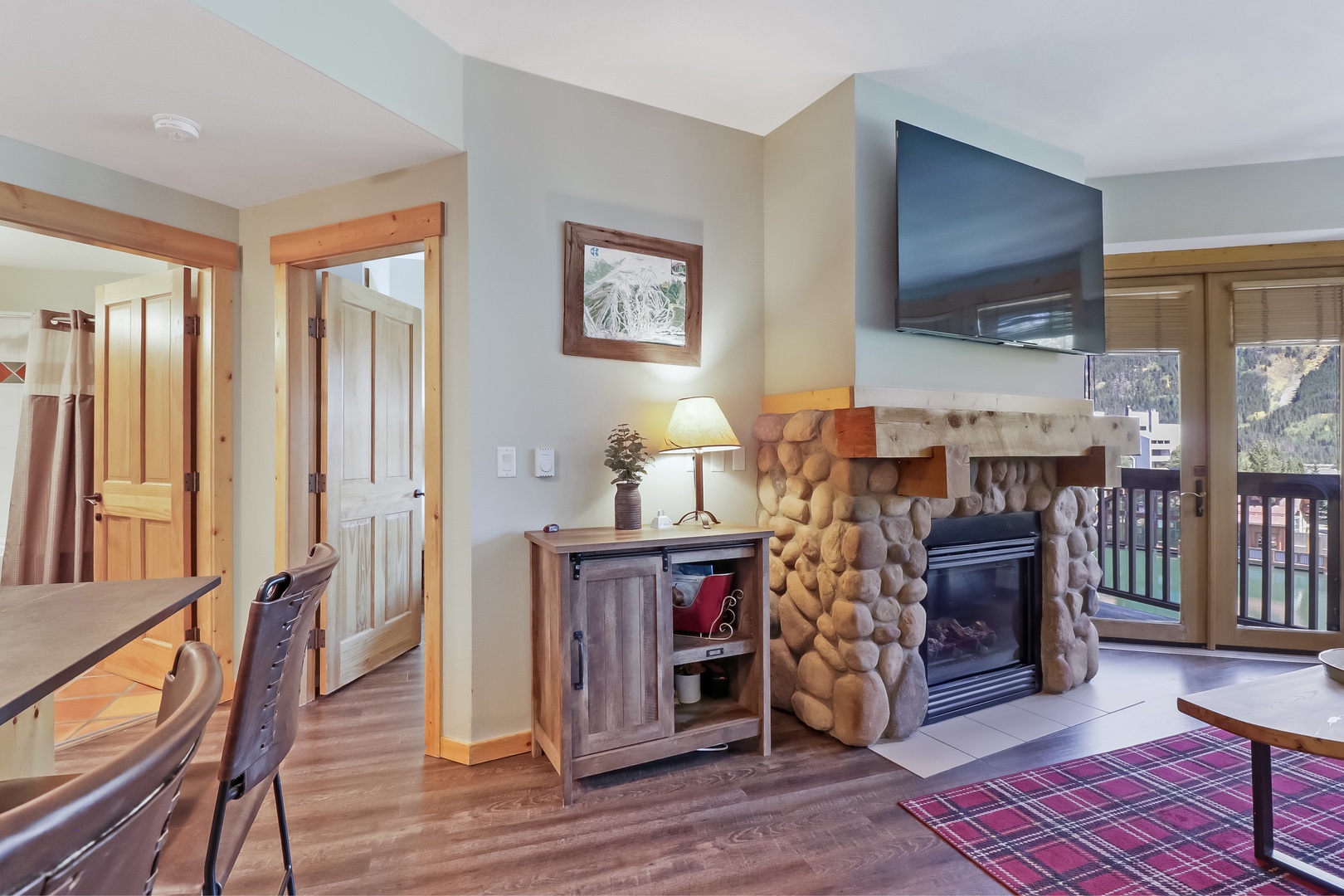 Cozy up by your private fireplace with rustic stone accents, or step through the balcony door to take in mountain views from your own outdoor space.