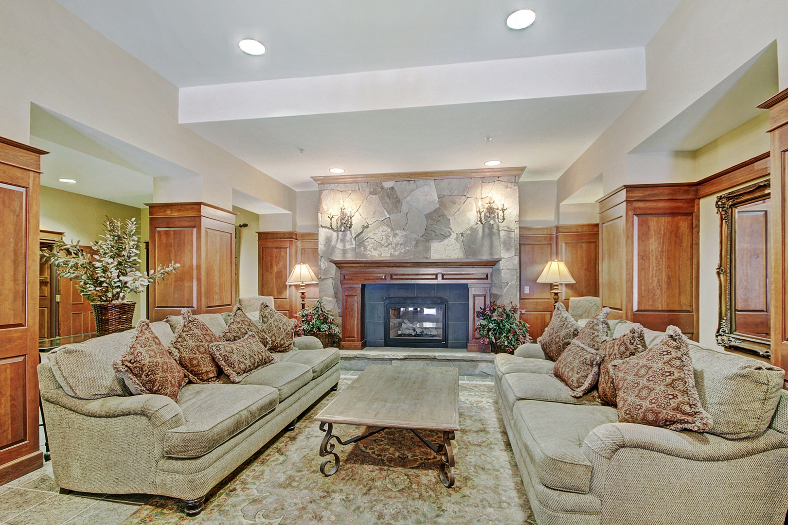 Warm up by the stone fireplace in this inviting lounge, where plush sofas and elegant wood accents create your perfect retreat after a day of adventure.
