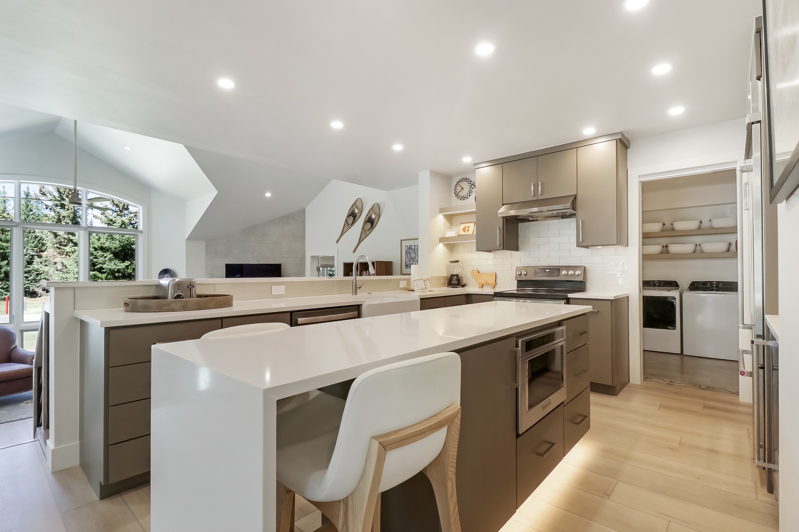 Your gourmet kitchen features sleek quartz countertops, stainless appliances, and a breakfast bar perfect for morning coffee or meal prep in this bright, modern space.
