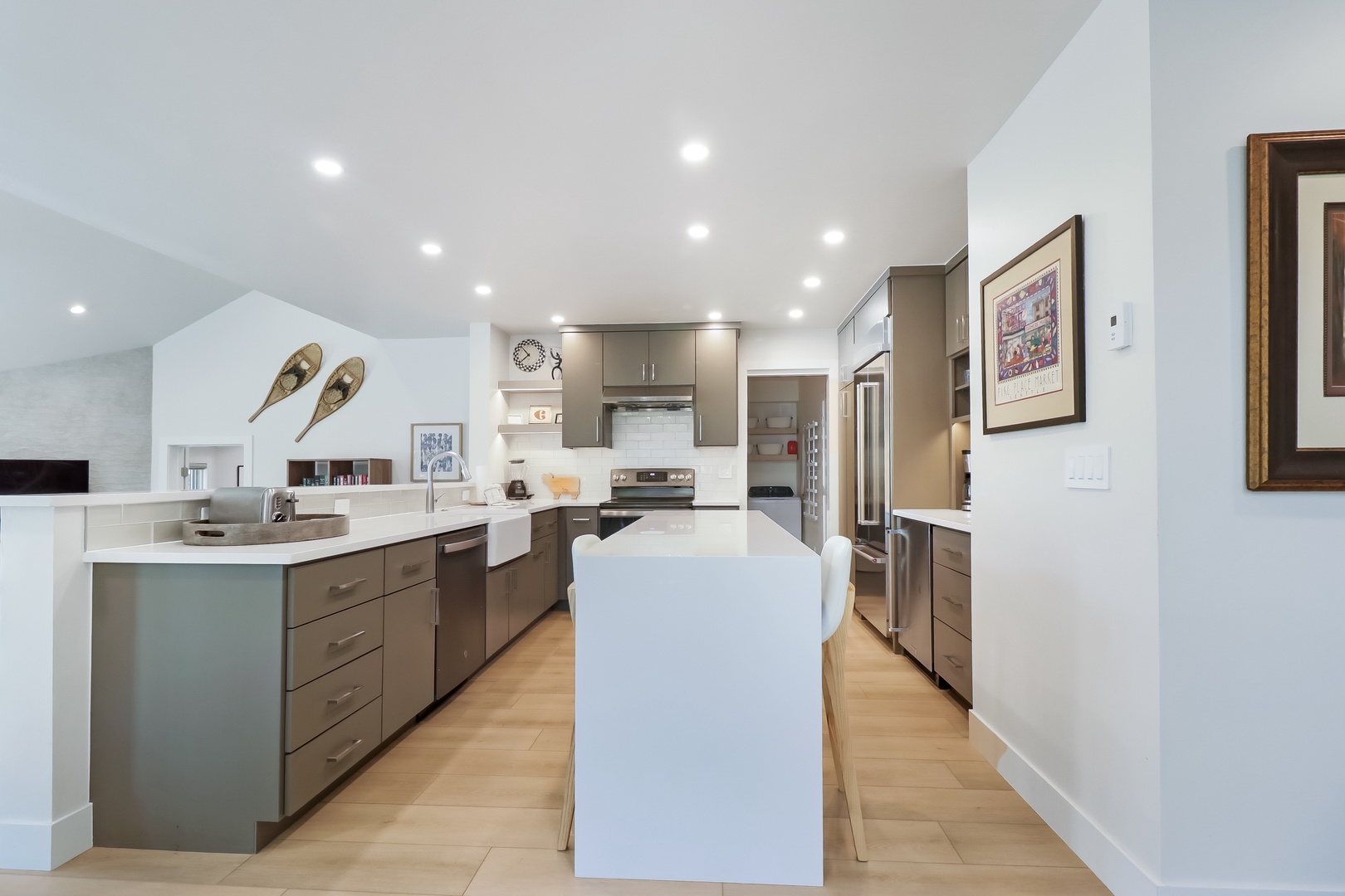 This spacious, modern kitchen invites you to prepare memorable meals with ample counter space, stainless steel appliances, and plenty of natural light streaming through open sightlines.