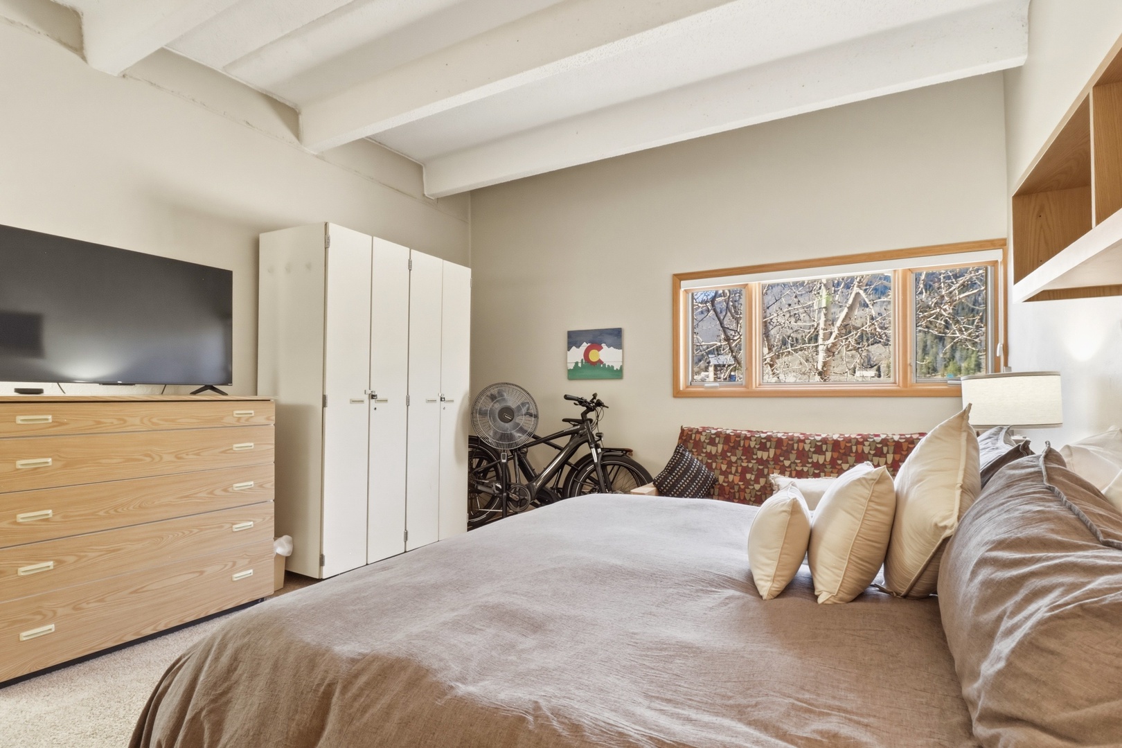 Unwind in your cozy bedroom with exposed beams, modern amenities, and abundant storage for all your travel essentials.