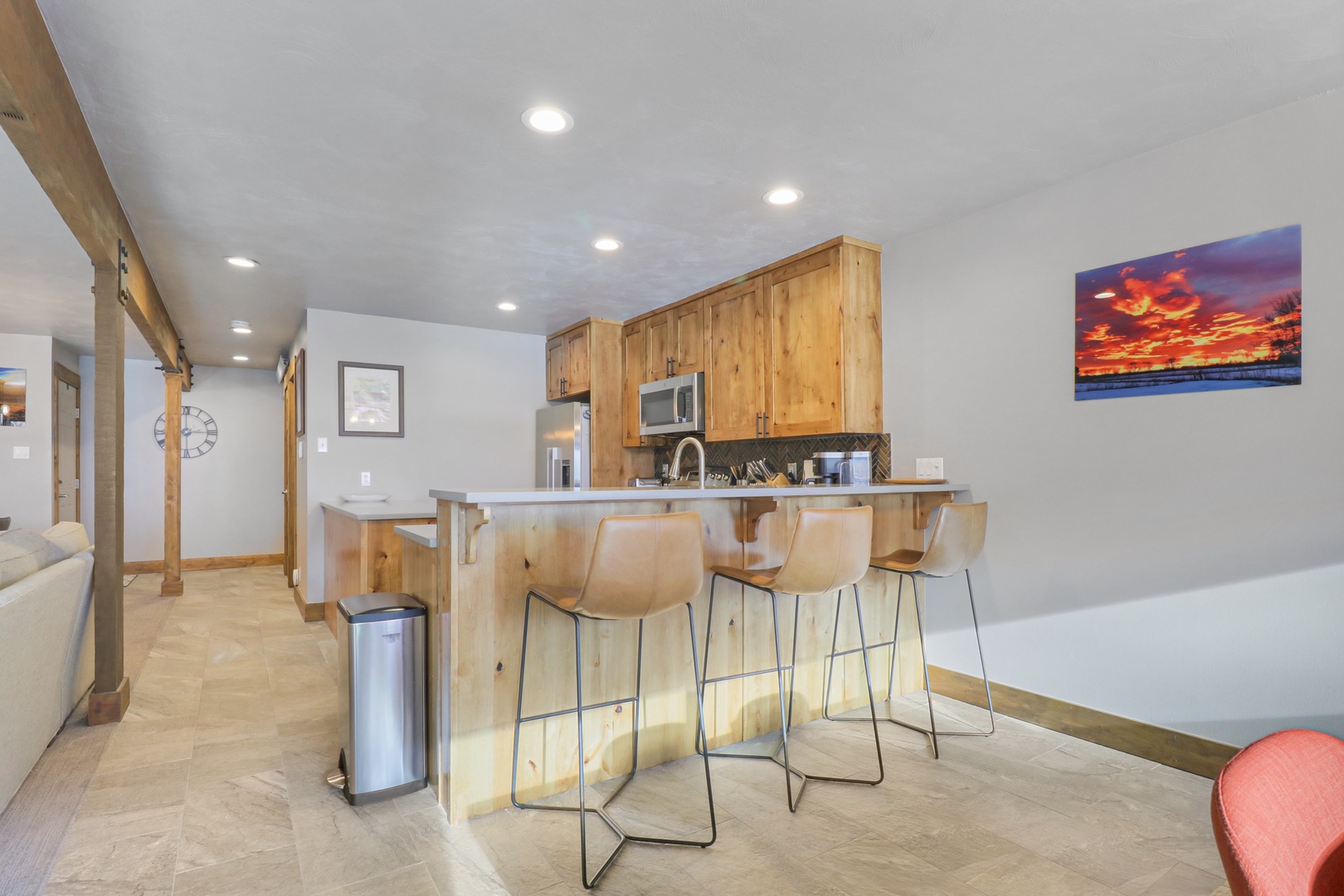 Gather around your beautiful breakfast bar where natural wood warmth meets modern convenience. You'll love preparing meals in this fully-equipped kitchen while chatting with family.