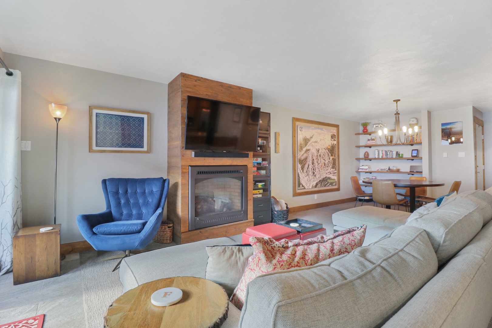 Sink into comfort in your stylish living space, where a cozy fireplace creates the perfect ambiance for relaxing evenings. The warm wood accents and plush seating invite you to unwind after your adventures.