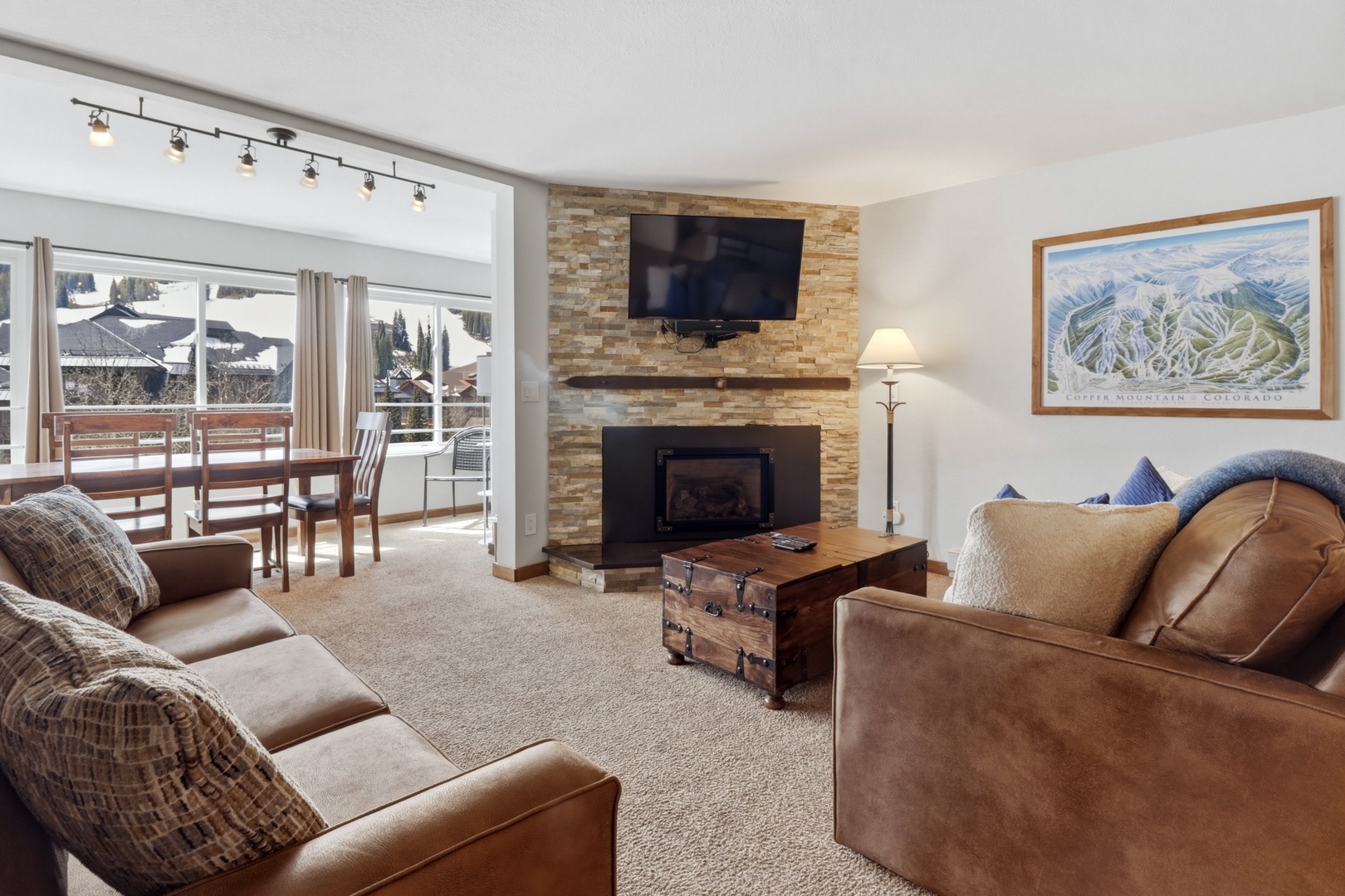 Cozy up in your spacious living room with plush leather seating and a warm fireplace after mountain adventures.