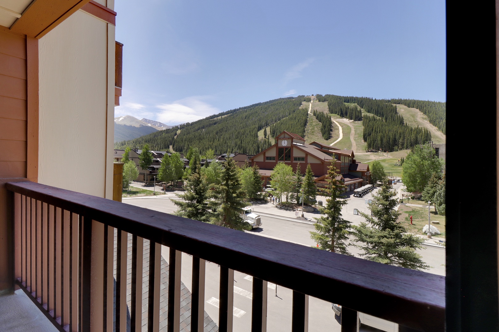 Expansive mountain vistas showcase ski slopes, surrounding peaks, and a charming alpine village framed by evergreen trees—an impressive backdrop for your mountain getaway.