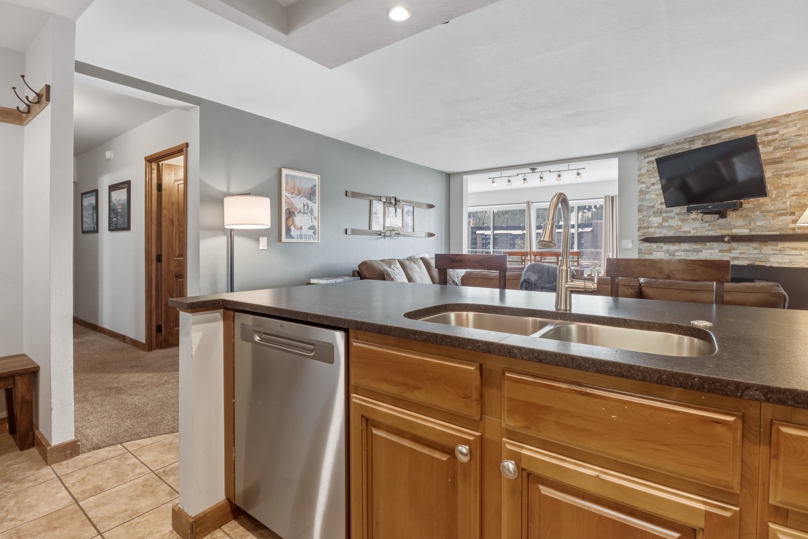 Your modern kitchen flows seamlessly into the cozy living space, featuring granite counters and stainless appliances for effortless vacation cooking.