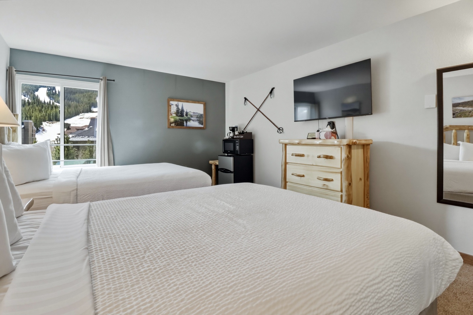 Drift off in crisp white linens while enjoying snowy mountain views from your cozy twin bedroom sanctuary.