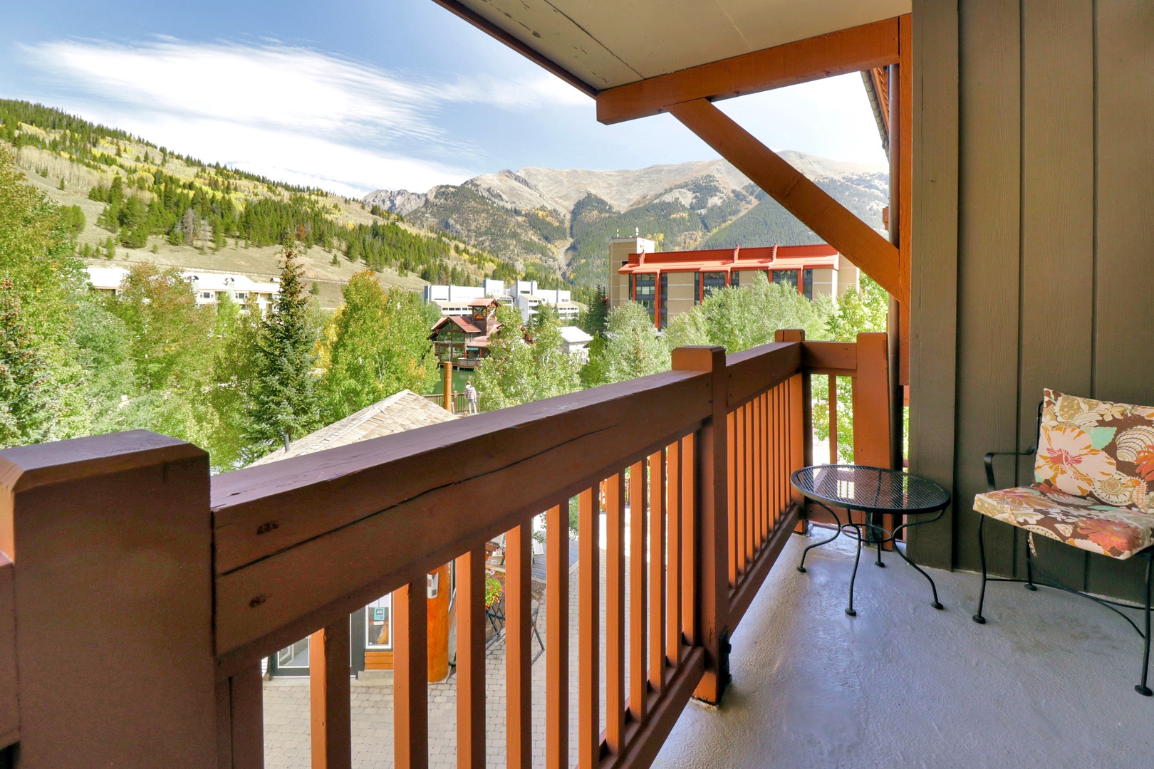 Step onto your private balcony and soak in sweeping mountain vistas framed by evergreen forests. The intimate bistro set invites you to savor morning coffee or unwind with evening views of the peaks.