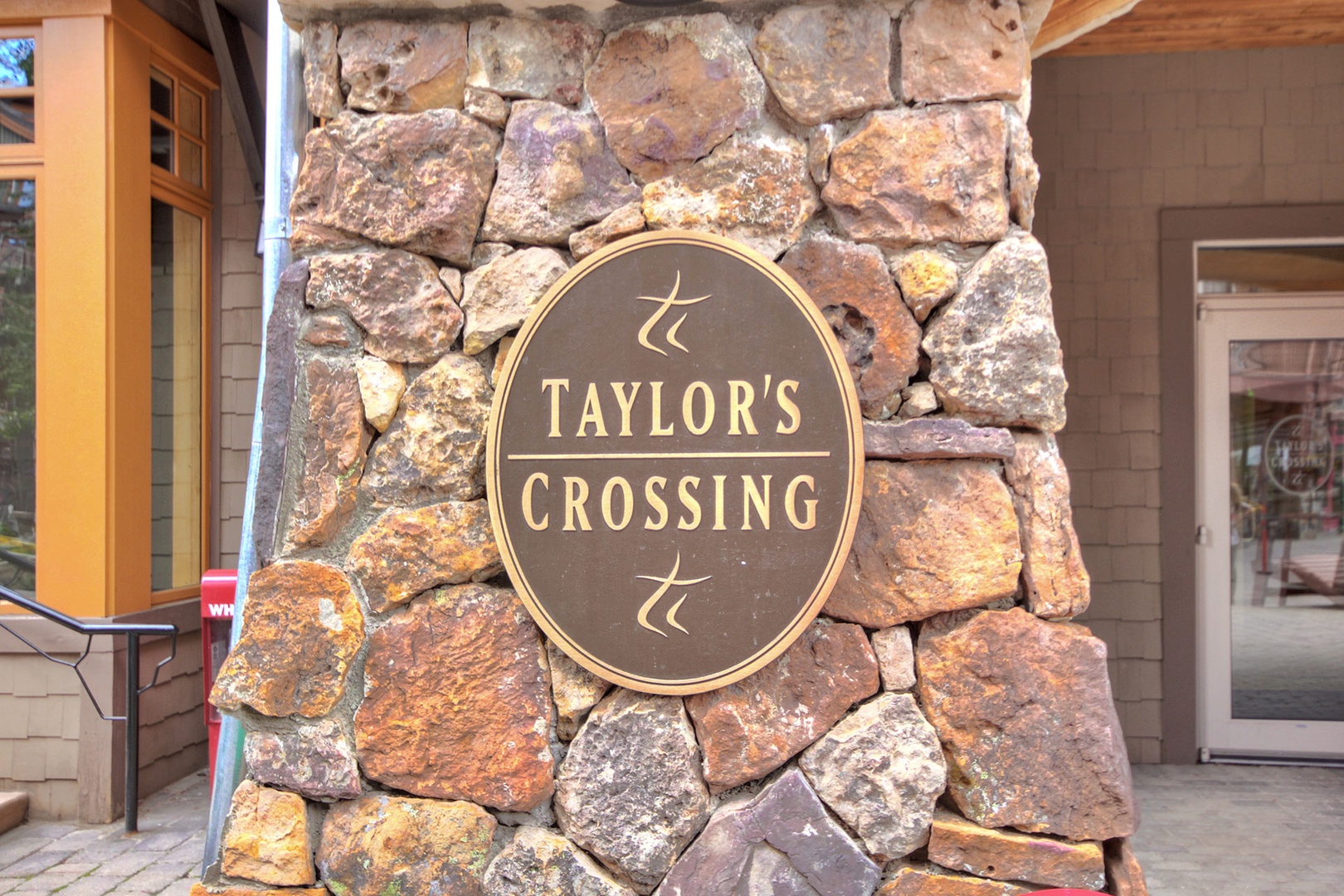 Taylor's Crossing welcomes you with its distinctive stone entry marker and rustic mountain elegance, setting the tone for your arrival at this inviting property.