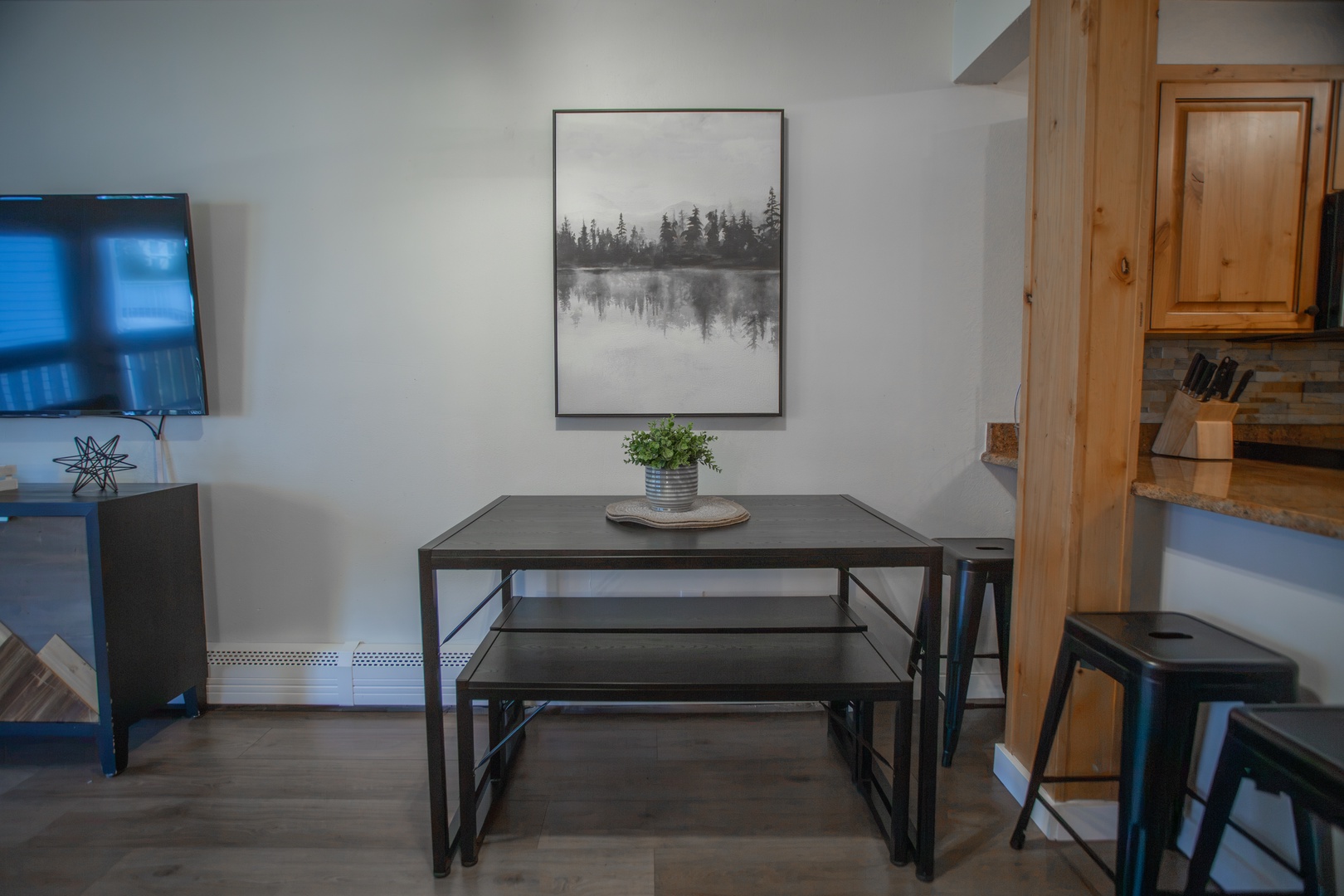 Gather around your modern dining table for relaxed meals. The minimalist setup with benches and sleek chairs provides a cozy spot for four, perfect for morning coffee or evening conversations.