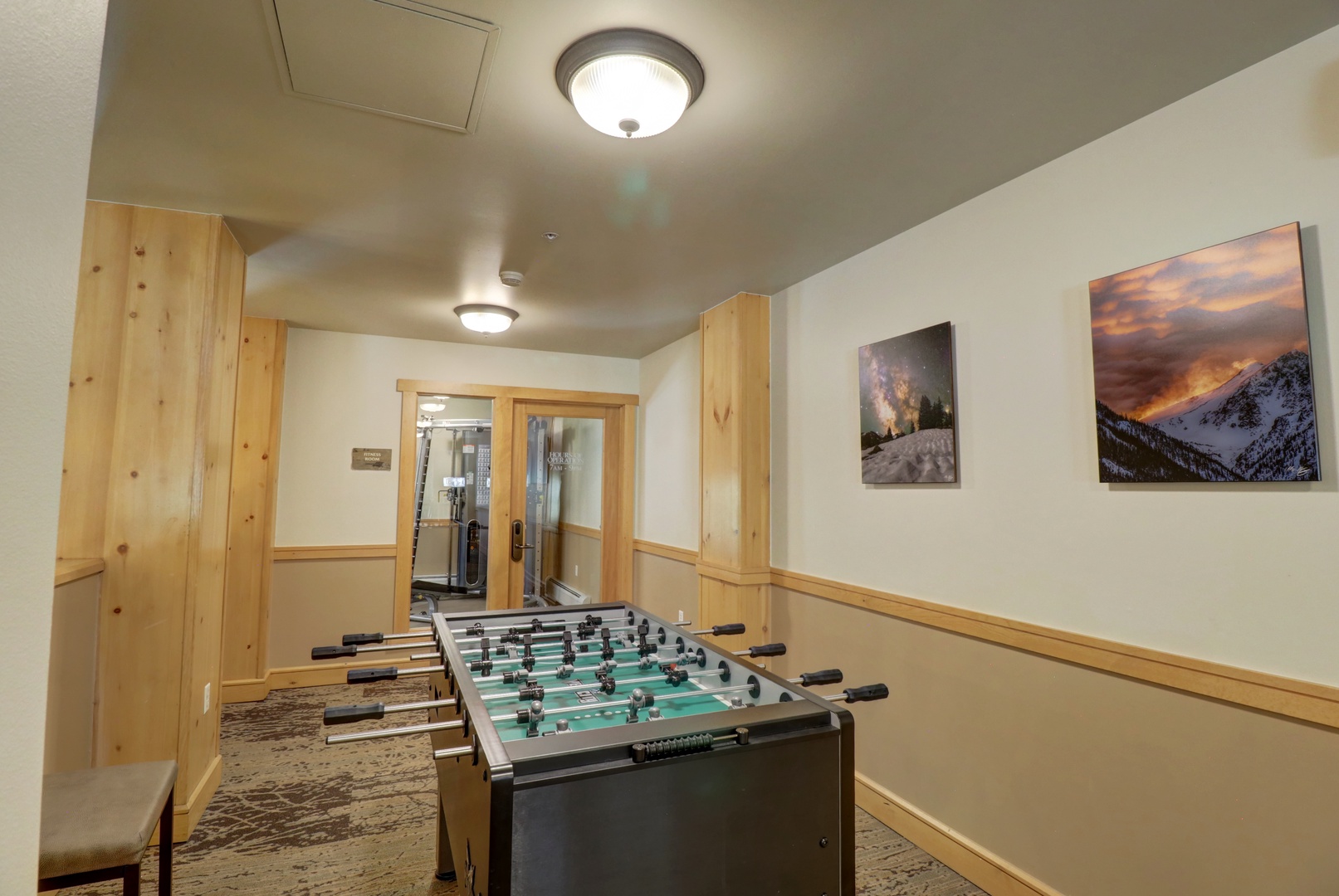 Challenge your travel companions to a friendly foosball match in this inviting game room, complete with mountain-inspired artwork that captures the spirit of your alpine getaway.