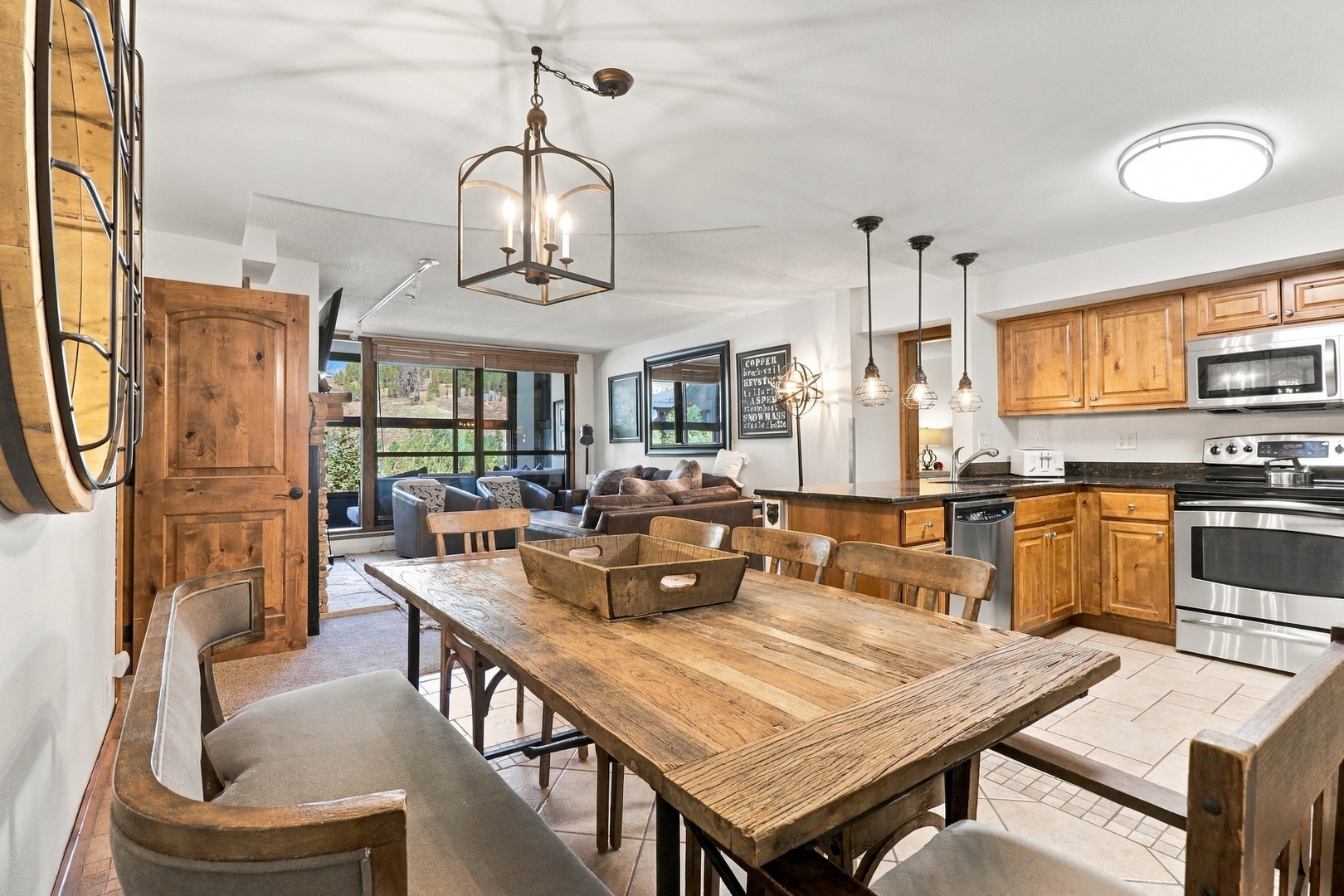 Step into rustic elegance with warm wood tones and natural light throughout this open-concept space. A farmhouse dining table, fully equipped kitchen, and cozy living area create the perfect mountain retreat for gathering and unwinding.