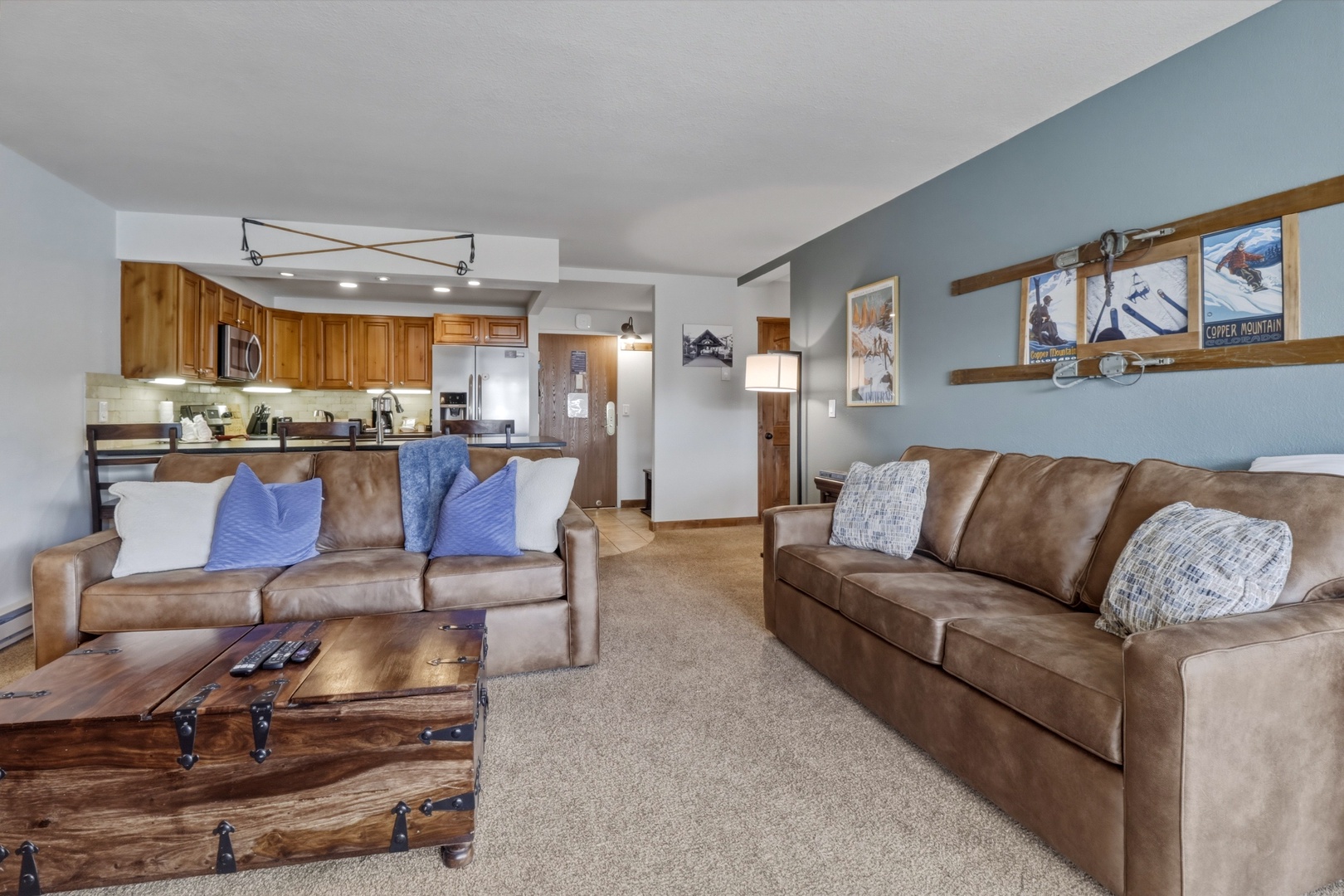 Relax in your spacious living area with comfortable leather sofas and rustic mountain decor, perfect for unwinding after your adventures.