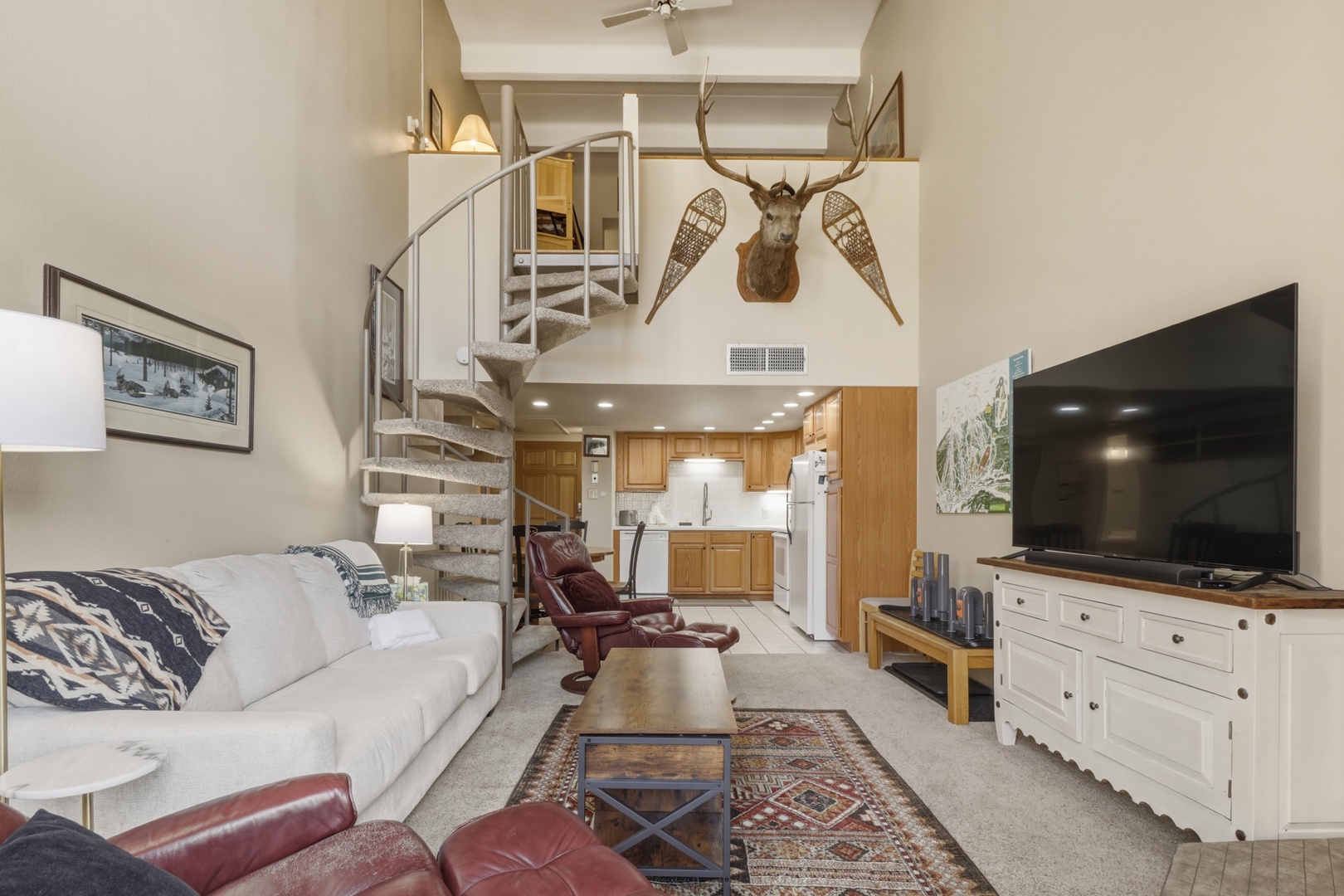 Step into your mountain-inspired loft where rustic charm meets modern comfort—spiral stairs lead to your private retreat above.