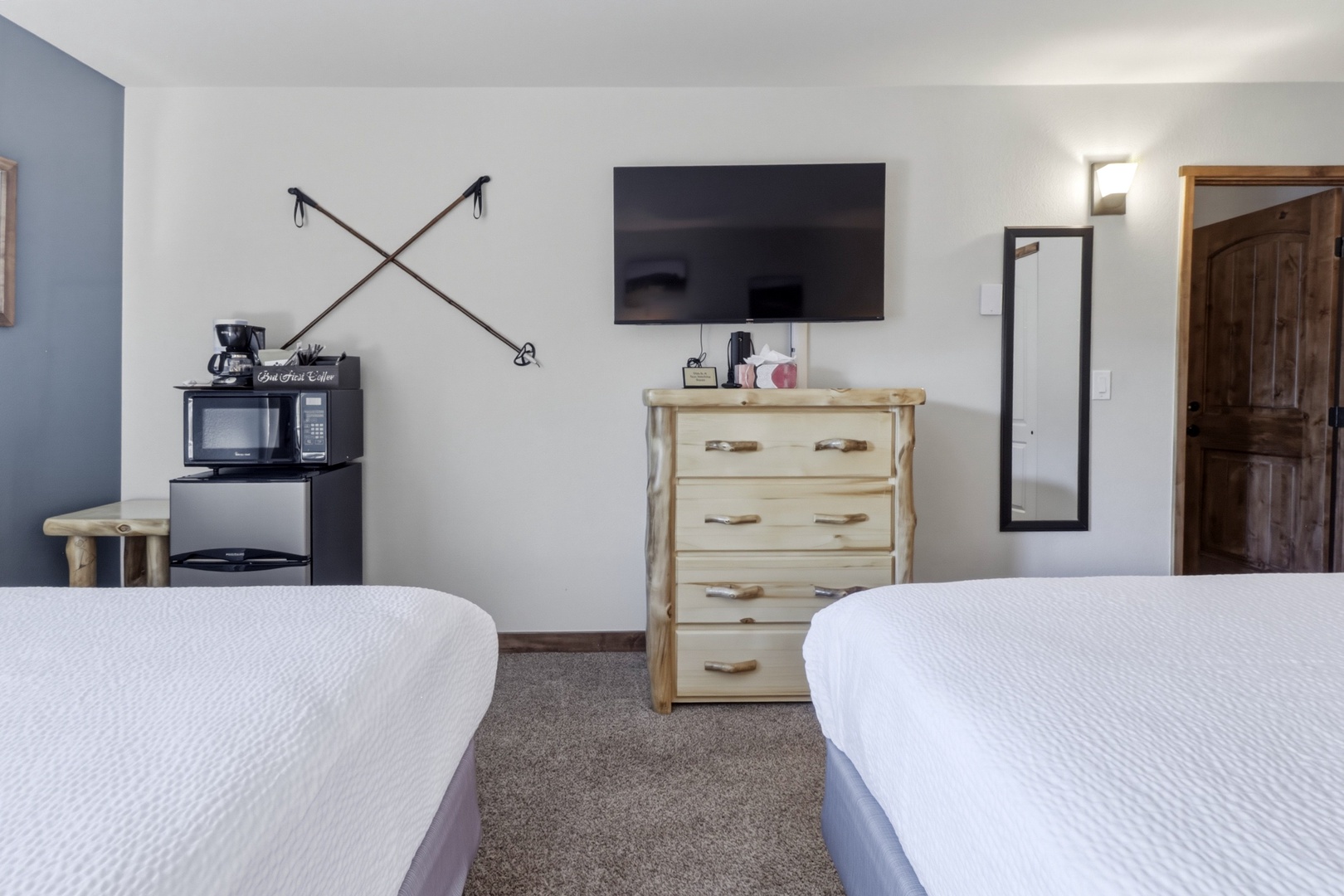Your cozy bedroom features rustic wooden furnishings, modern amenities like coffee facilities and flat-screen TV, creating the perfect mountain retreat atmosphere.