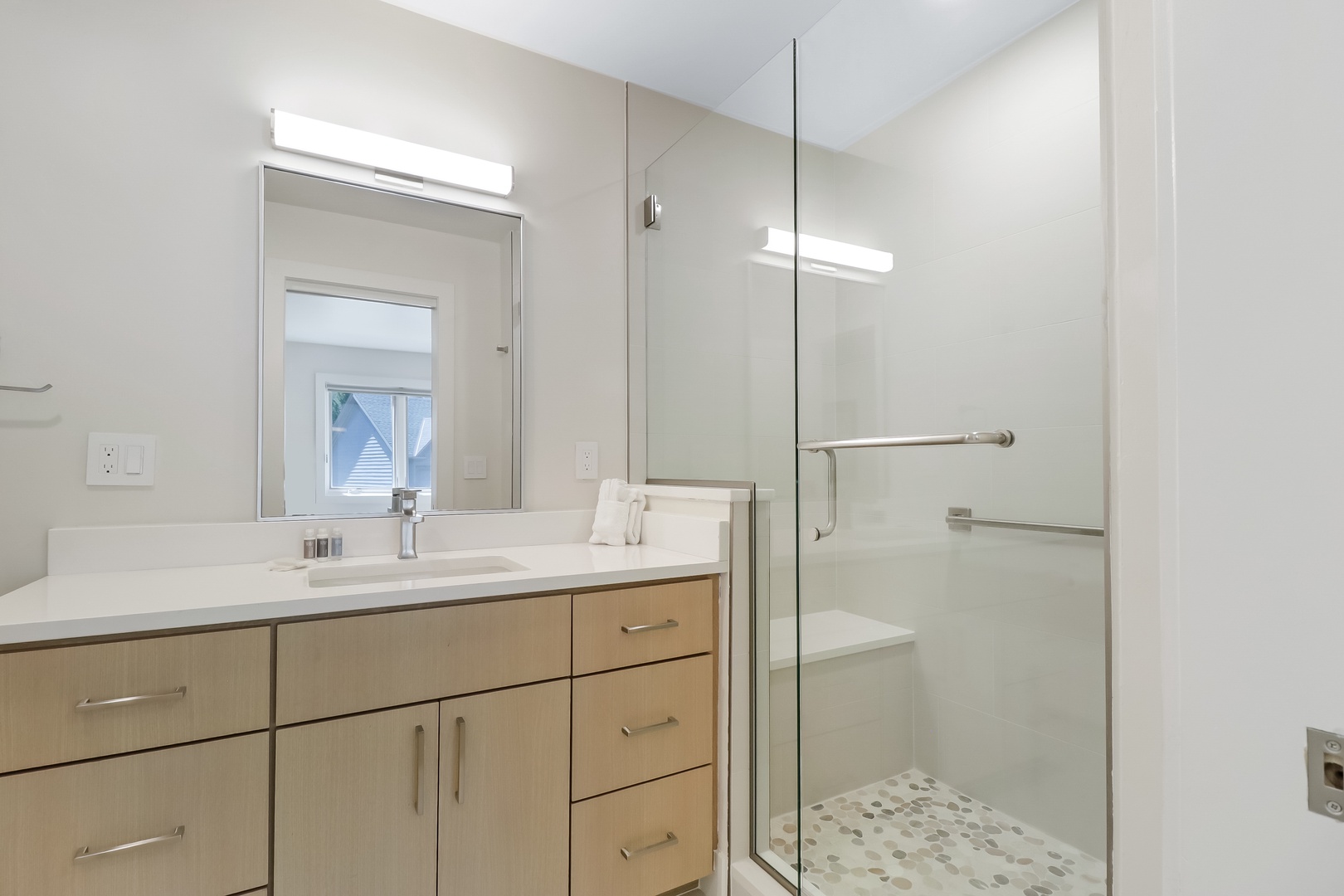 Freshen up in your pristine, modern bathroom with a spacious walk-in shower, sleek finishes, and ample storage to make you feel right at home.
