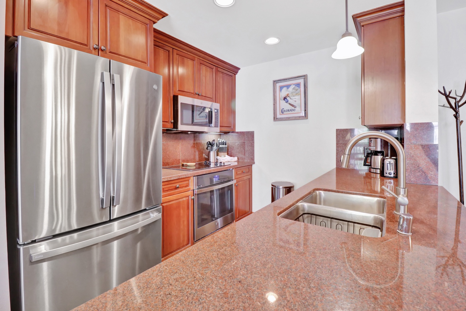 Step into a well-appointed kitchen with sleek stainless appliances, polished countertops, and warm wood cabinetry. Everything you need awaits to prepare your favorite meals in style.