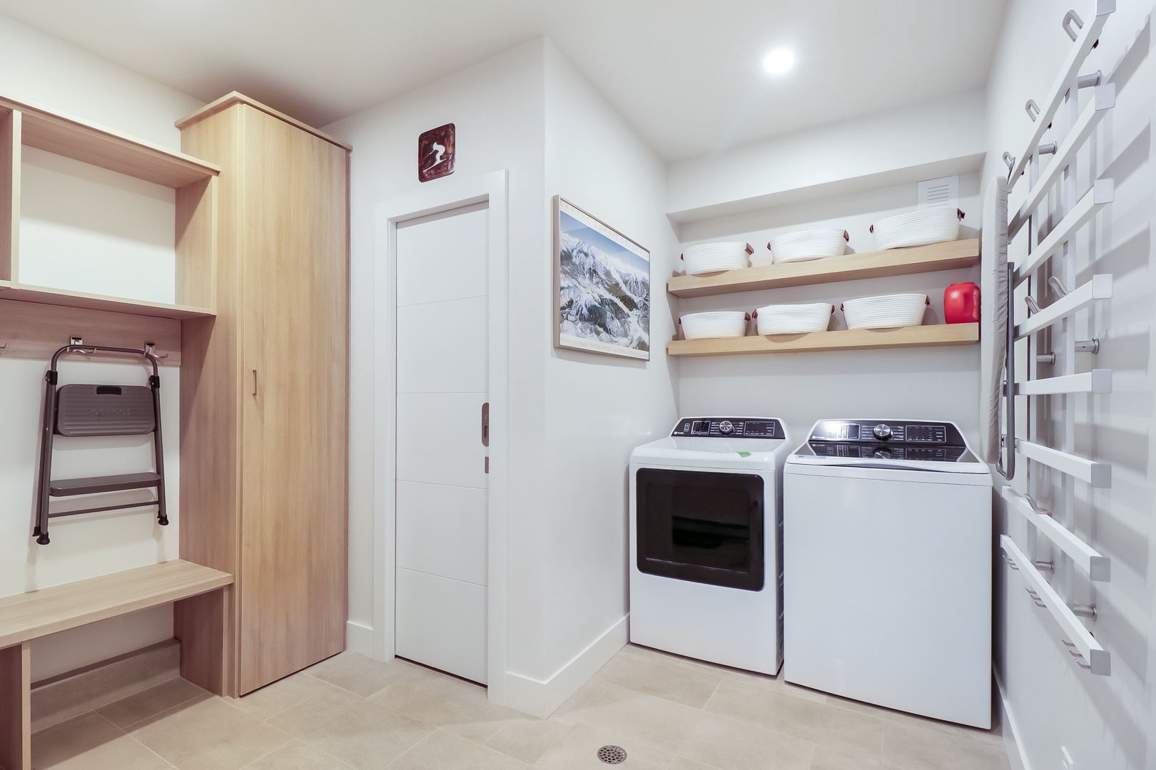 Your dedicated laundry room features full-size washer and dryer, custom shelving for supplies, and ample storage space to keep everything organized and within reach.
