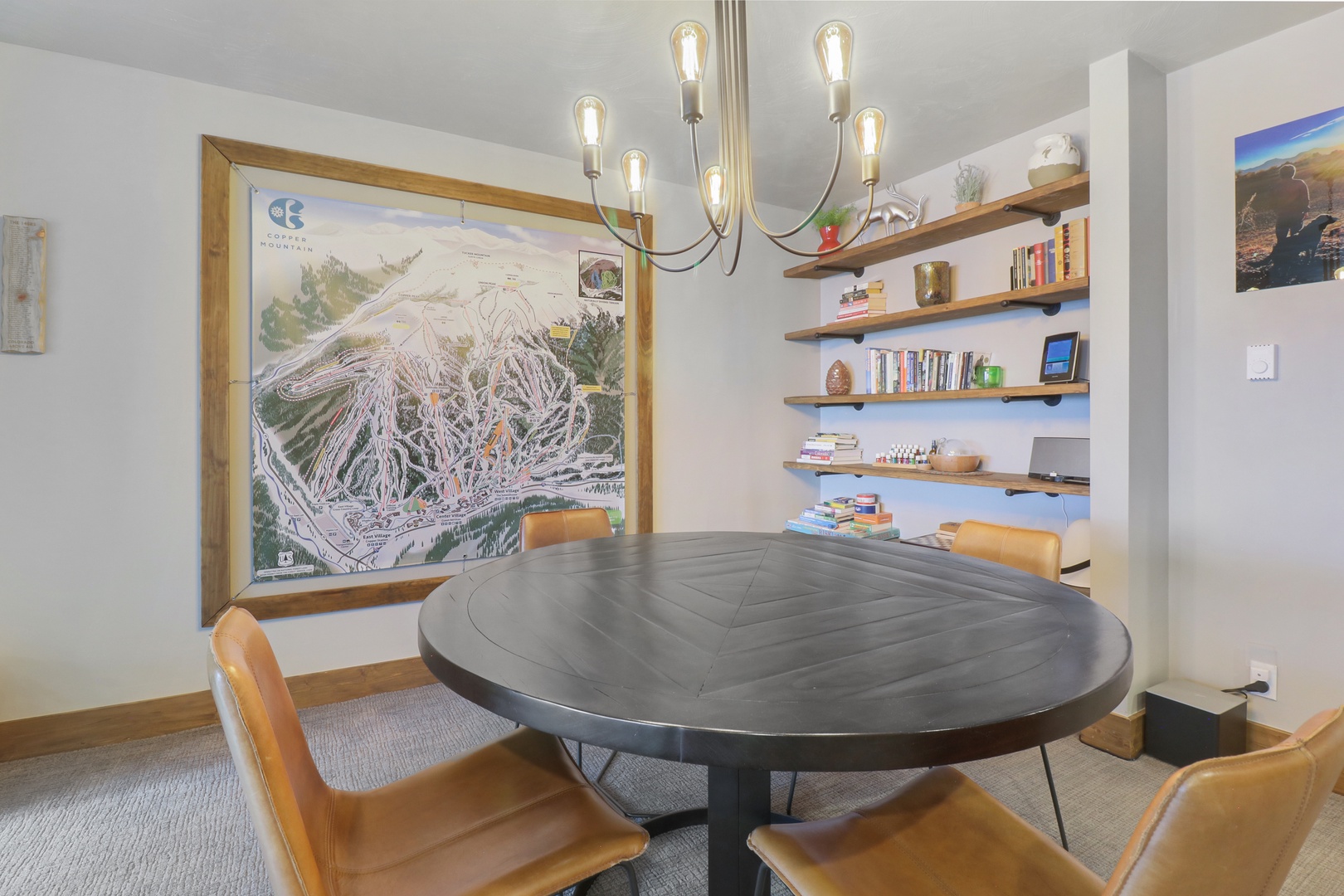 Gather around your stylish dining table where warm Edison bulb lighting creates the perfect ambiance for memorable meals and conversations with loved ones.