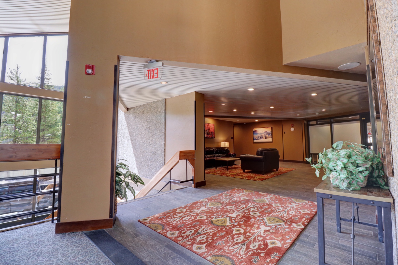 The welcoming lobby features high ceilings, natural light from large windows, and comfortable seating areas that create an inviting arrival experience.