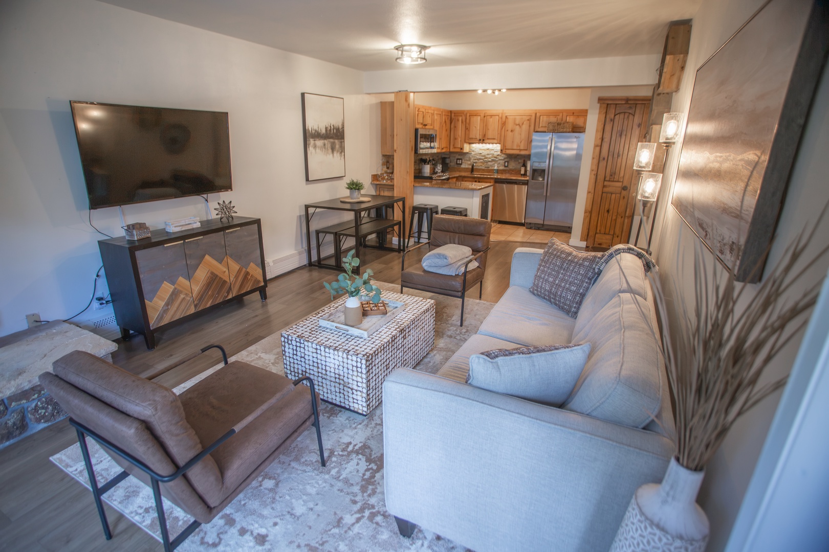 Unwind in your open-concept living space, where warm wood tones and modern comfort create the perfect mountain retreat. Relax on plush seating, prepare meals in your fully equipped kitchen, and gather around the cozy dining table.