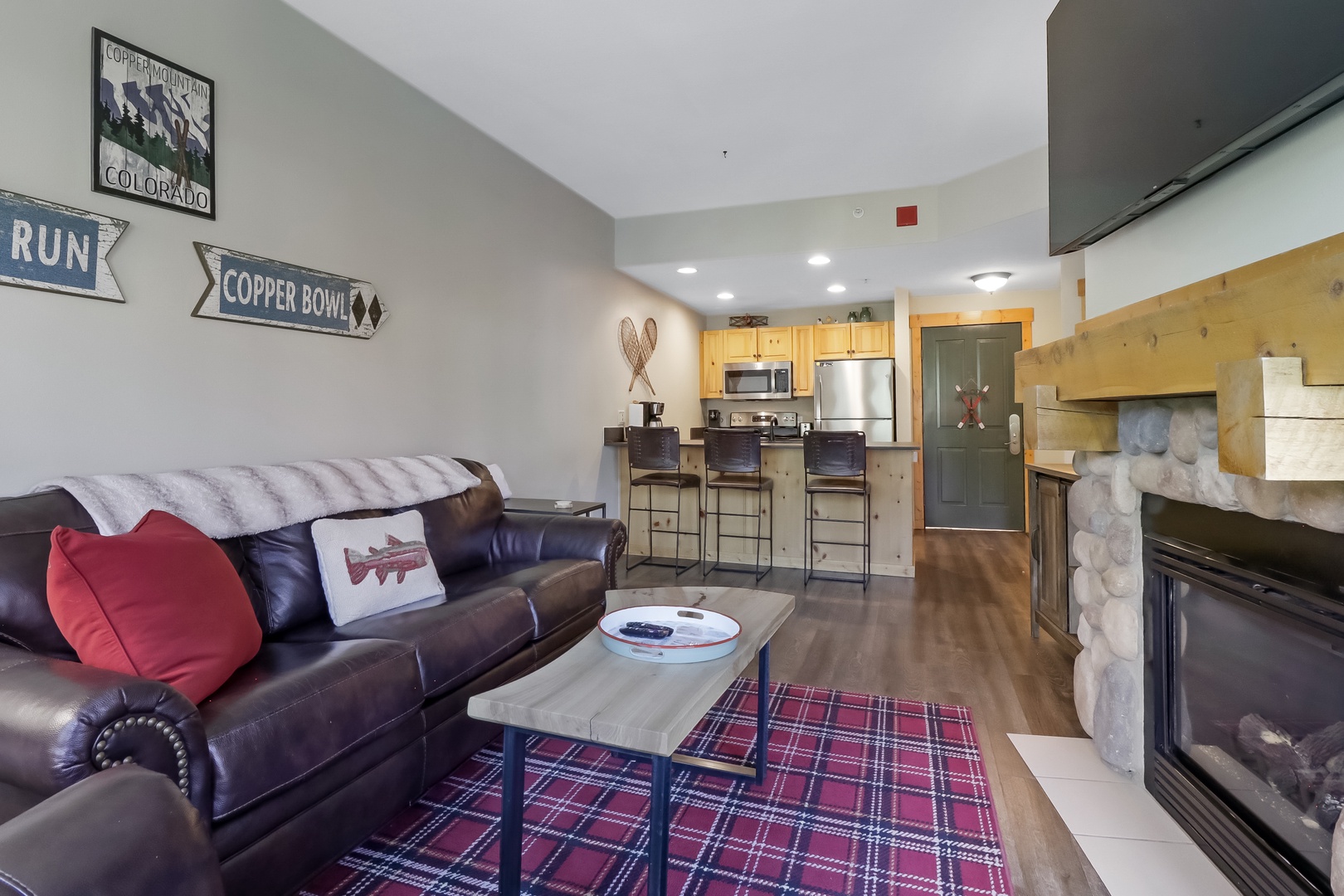 Unwind in your mountain-inspired retreat where rustic stone accents meet modern comfort, complete with cozy seating, a warming fireplace, and a fully equipped kitchen ready for après-ski meals.